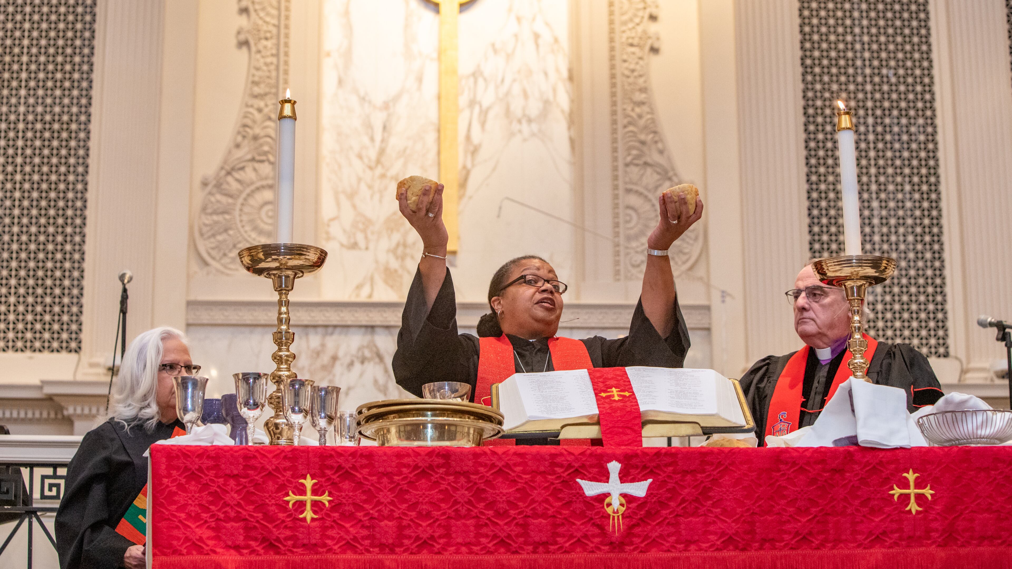 Bishop Robin Dease, right, breaks bread for communion during her installed as leader of the North Georgia Conference United Methodist Church on Sunday, Jan 8, 2023. She is the first African-American female appointed to the position. (Jenni Girtman for the Atlanta Journal-Constitution)