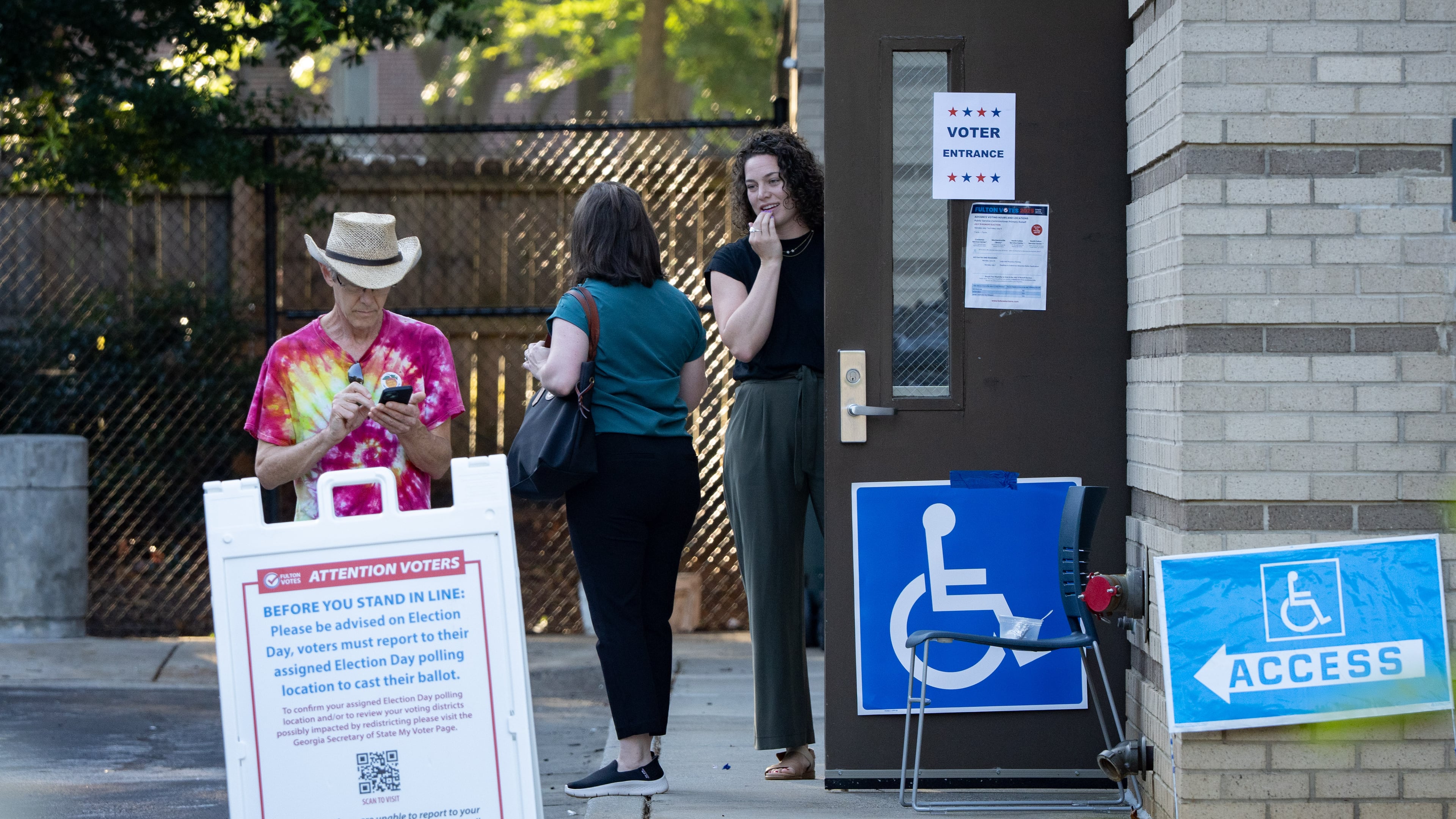 Voters stand outside the Joan P. Garner Library voting precinct in Atlanta to vote in the Georgia Public Service Commission runoff election Tuesday, July 15, 2025. (Ben Hendren for the AJC)