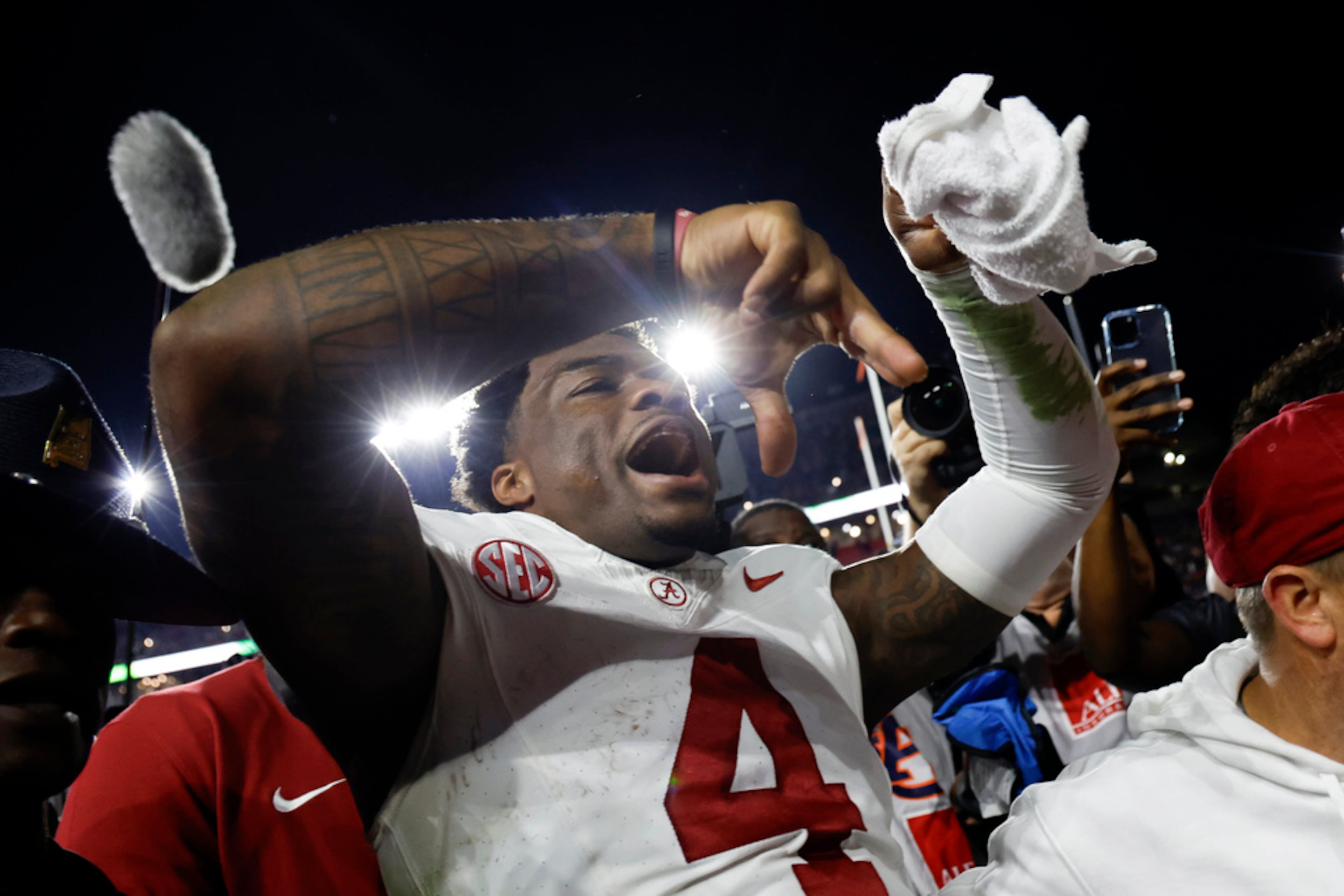 Alabama quarterback Jalen Milroe celebrates as he walks off the field after defeating Auburn in an NCAA college football game Saturday, Nov. 25, 2023, in Auburn, Ala. (AP Photo/Butch Dill)