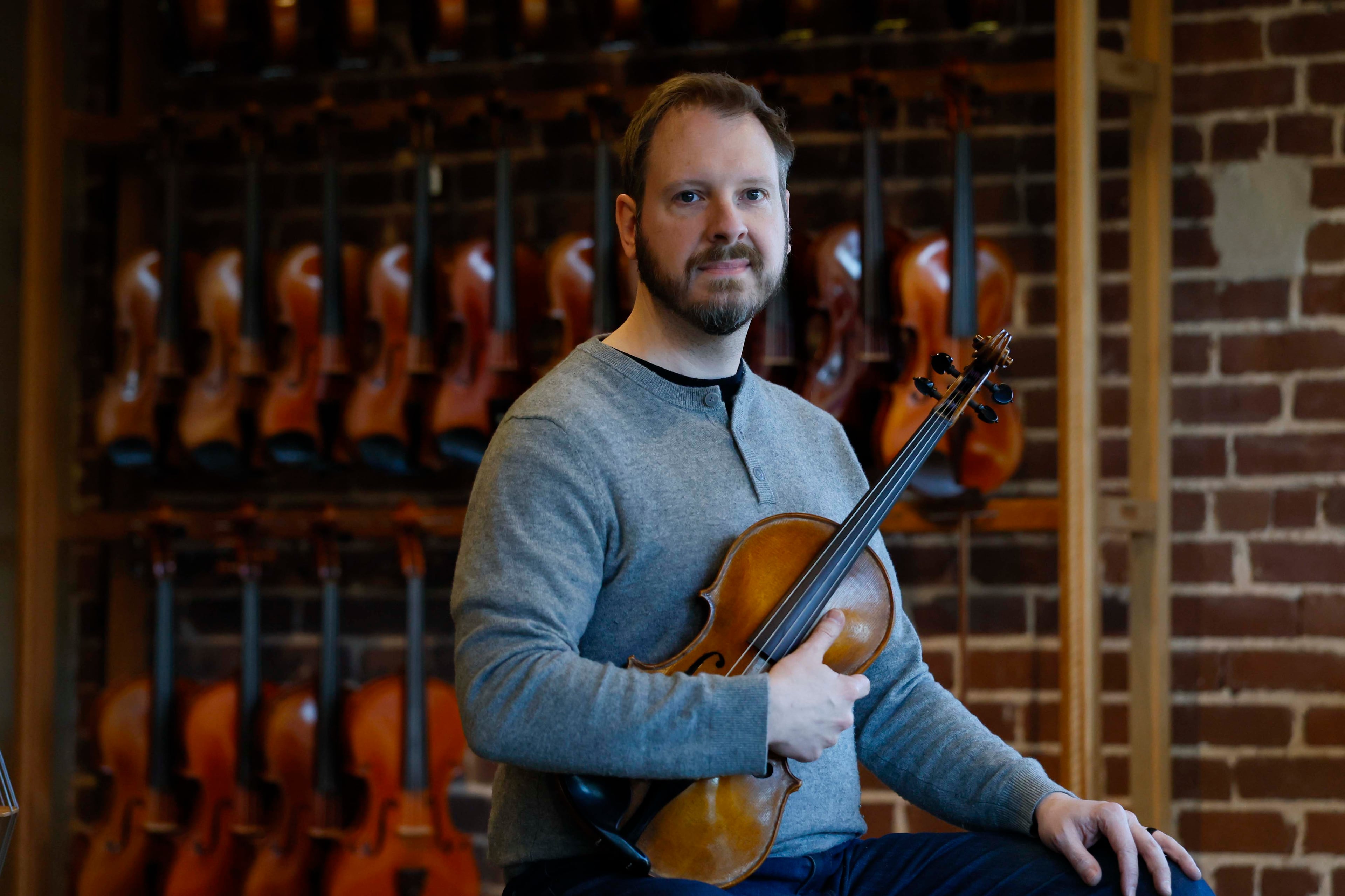 Andrew Henke, co-owner of the Ronald Sachs Violins in Avondale Estates, says he has dealt with increasing costs since the COVID-19 pandemic. (Miguel Martinez/AJC)