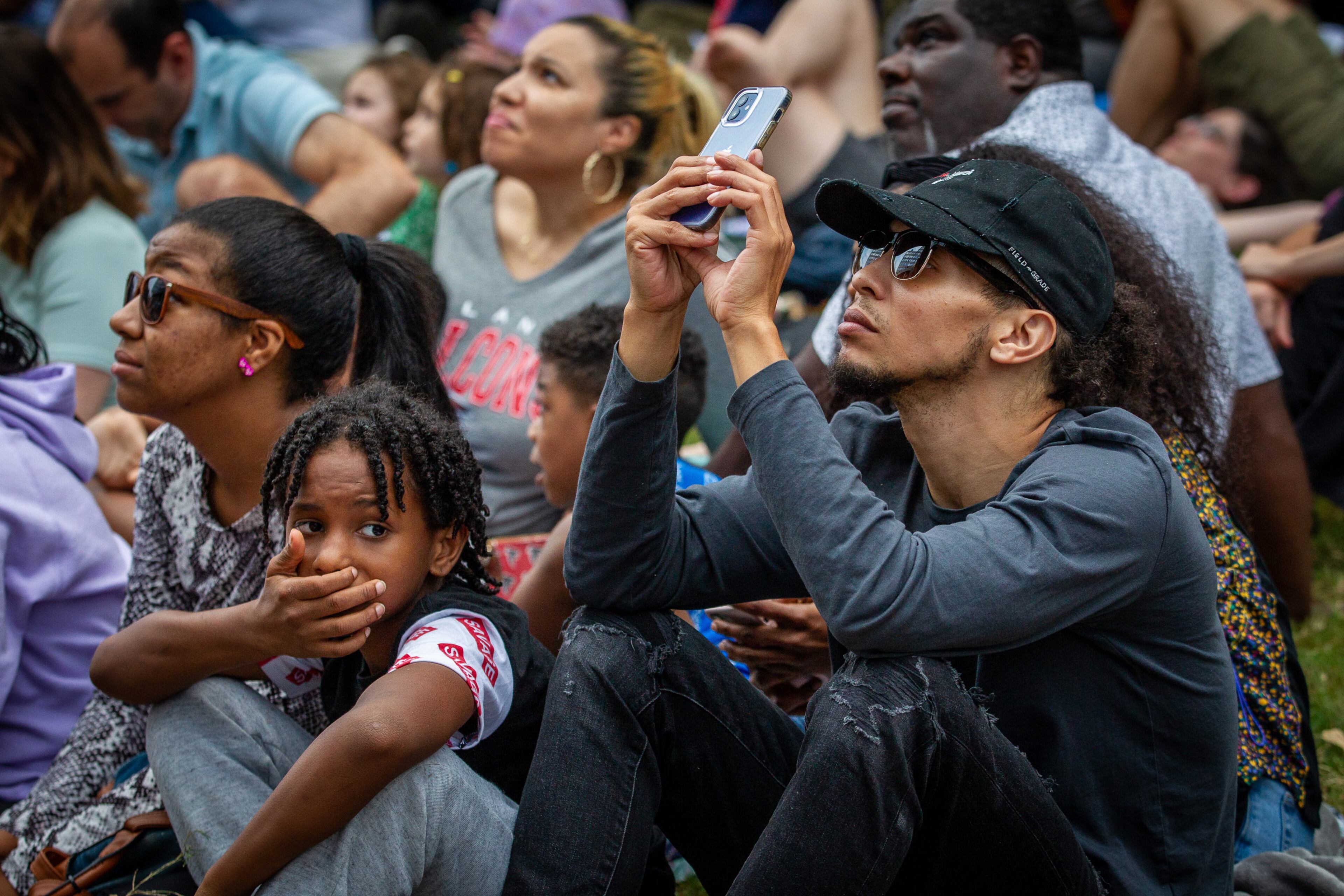 People take photos of the Bandaloop dancers performing on the side of a building facing the Atlanta Beltline on Sunday, October 3, 2021. (Photo: Steve Schaefer for The Atlanta Journal-Constitution)