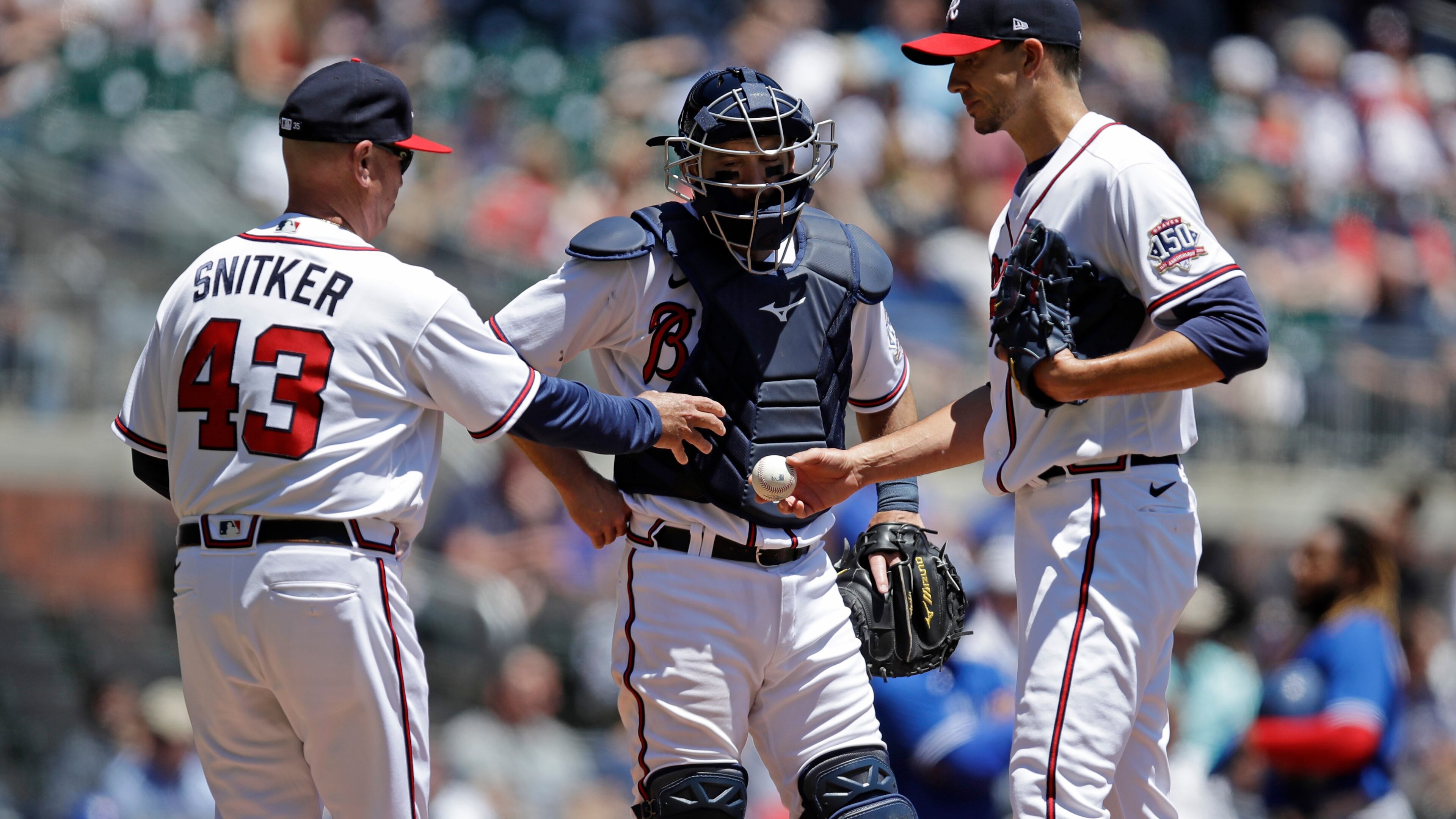 Atlanta Braves' Brian Snitker (43) takes the game ball from Charlie Morton in the fifth inning of a baseball game against the Toronto Blue Jays Thursday, May 13, 2021, in Atlanta. (AP Photo/Ben Margot)