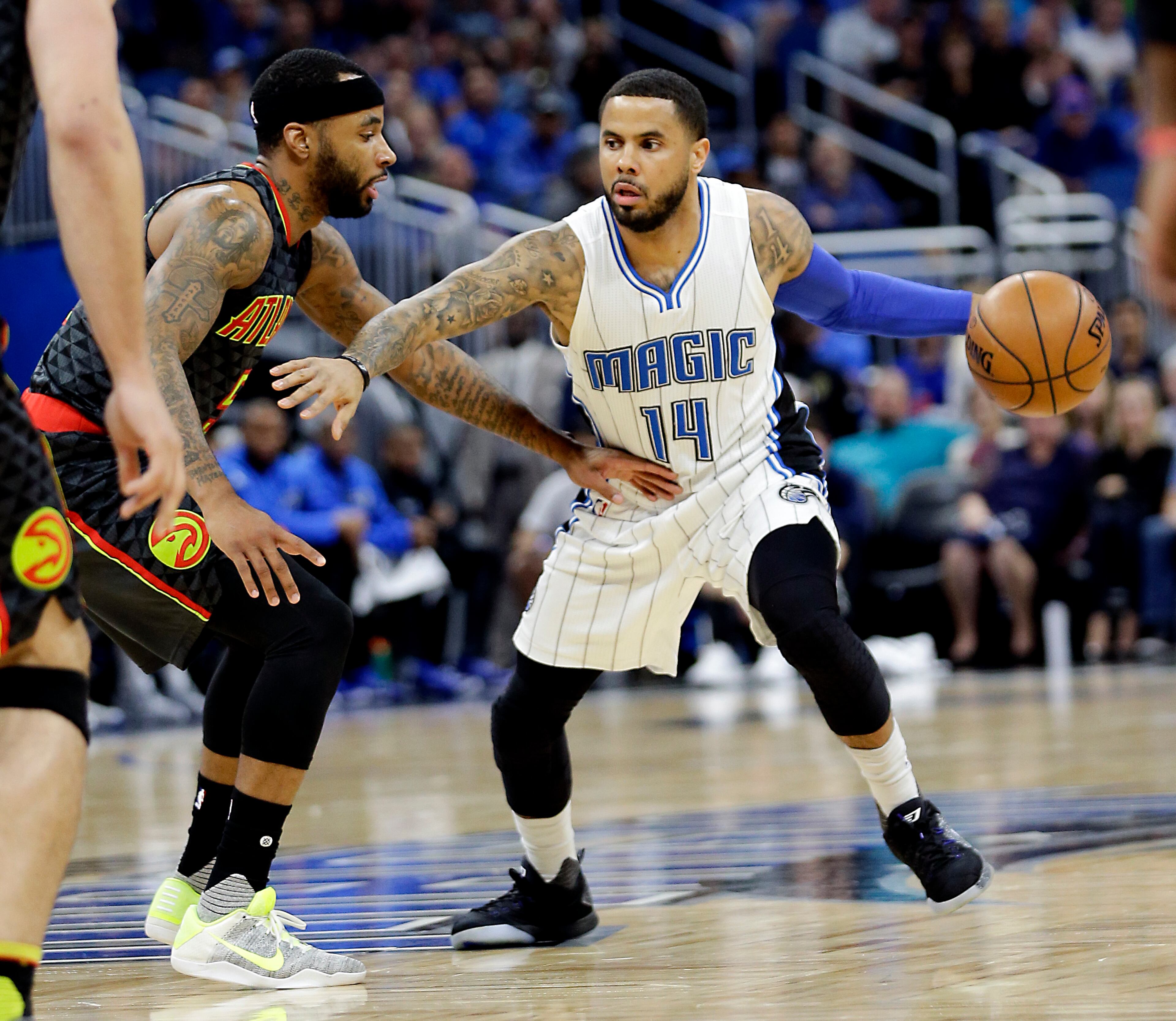 Orlando Magic's D.J. Augustin (14) moves past Atlanta Hawks' Malcolm Delaney, left, during the first half of an NBA basketball game, Wednesday, Jan. 4, 2017, in Orlando, Fla. (AP Photo/John Raoux)