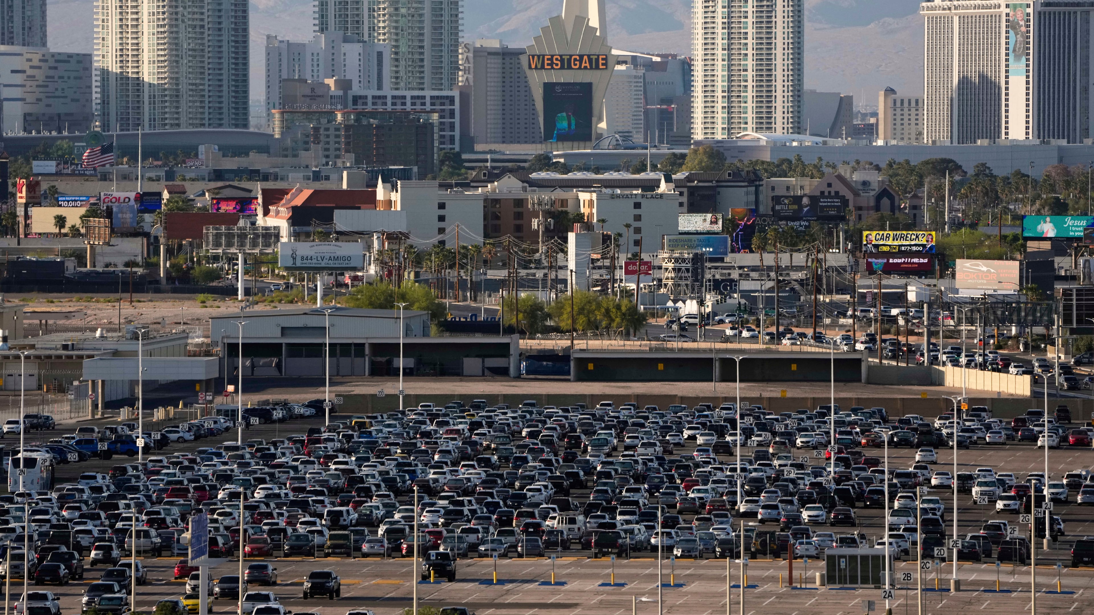 FILE - Cars fill a lot at Harry Reid International Airport near the Las Vegas Strip, April 9, 2025, in Las Vegas. (AP Photo/John Locher, File)