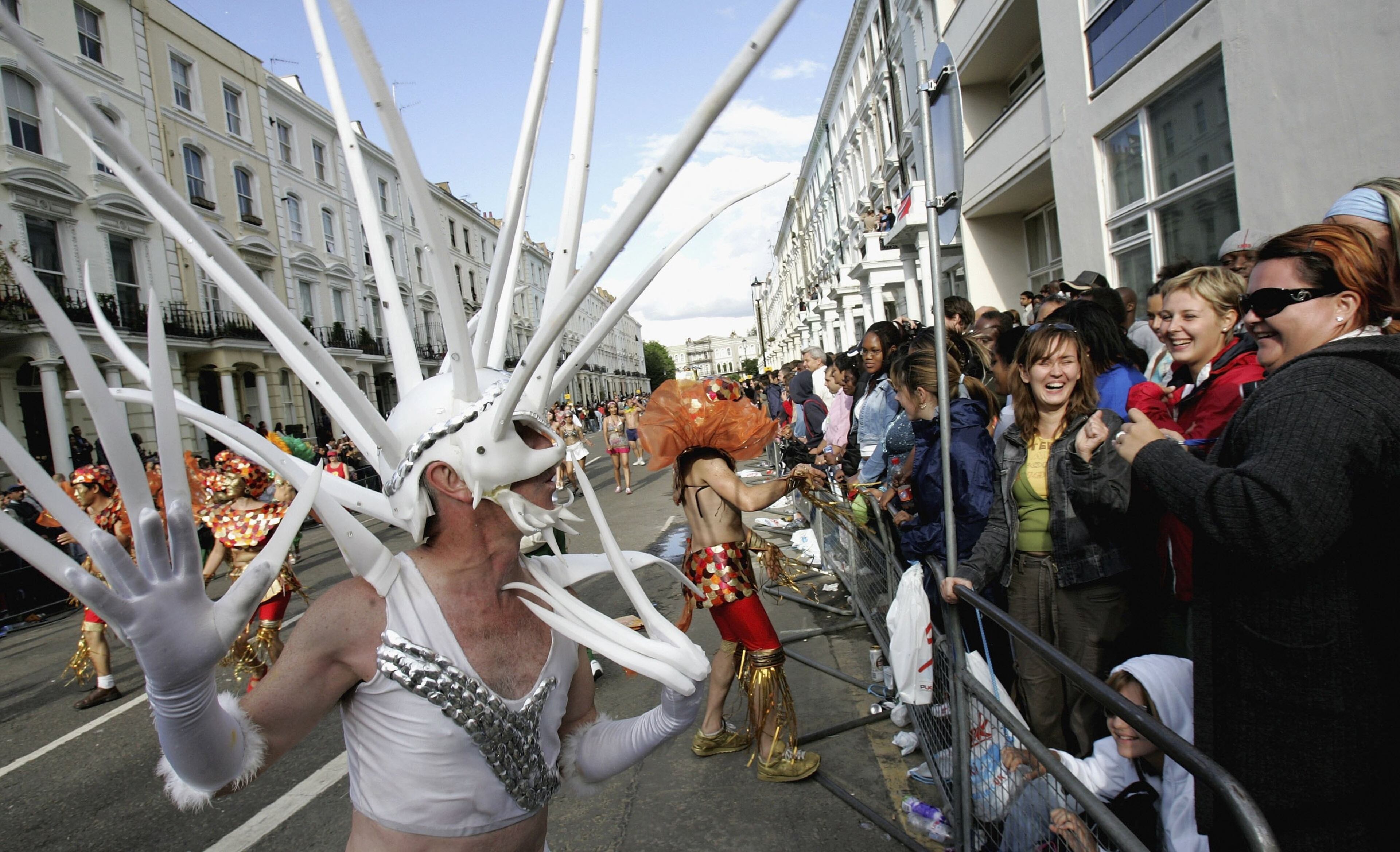 LONDON - AUGUST 28: A dancer taunts the crowd during the annual Notting Hill Carnival on August 28, 2006 in London, England. The first Notting Hill Carnival was first held in 1959 to celebrate the Caribbean culture of immigrants in the United Kingdom. The Carnival is now believed to be one of Europe's biggest street parties. (Photo by Chris Jackson/Getty Images)