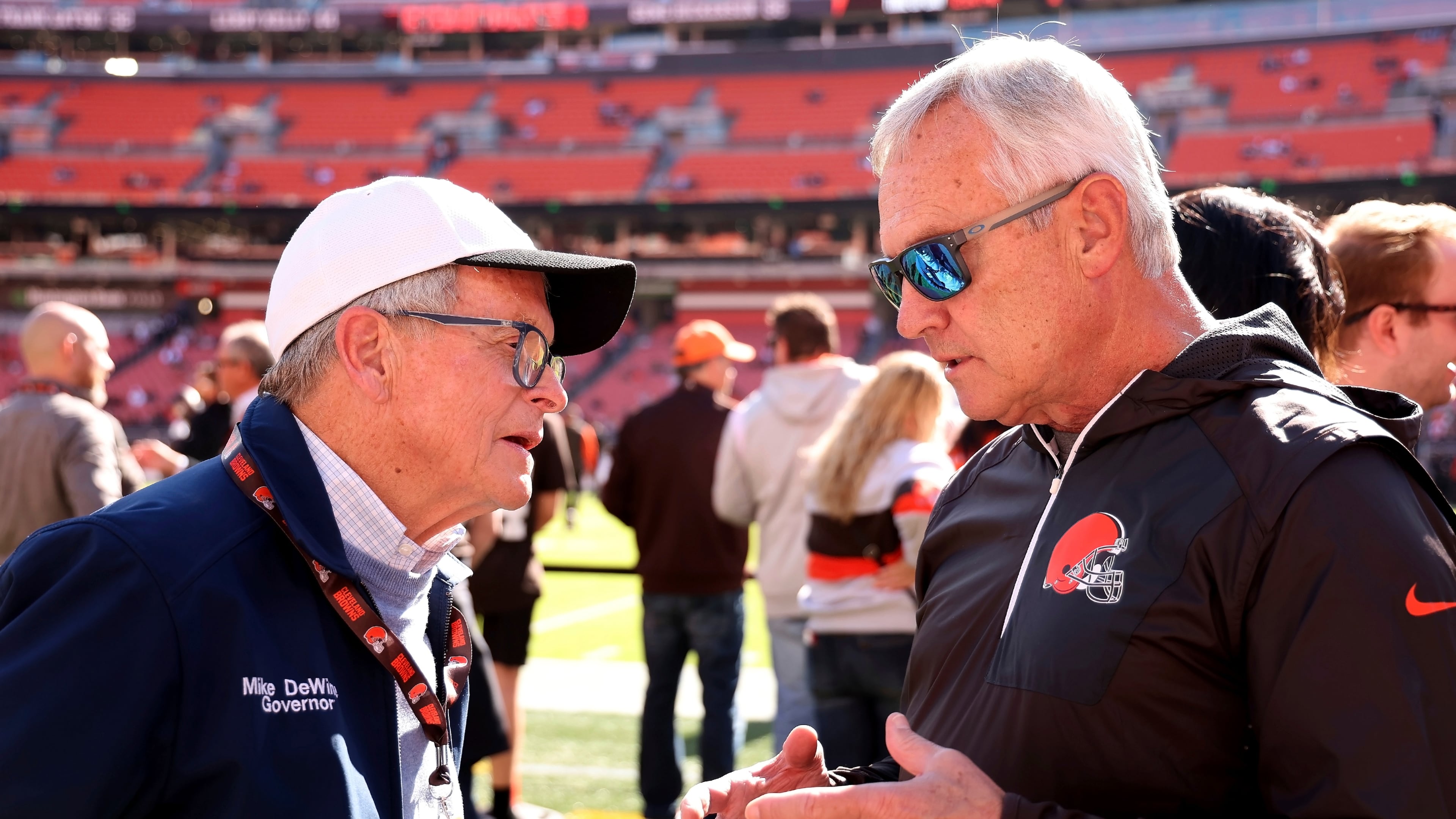 FILE - Ohio Gov. Mike DeWine talks with former Ohio State coach Jim Tressel while standing on the sideline prior to the start of an NFL football game between the Cincinnati Bengals and the Cleveland Browns, Oct. 20, 2024, in Cleveland. (AP Photo/Kirk Irwin, File)