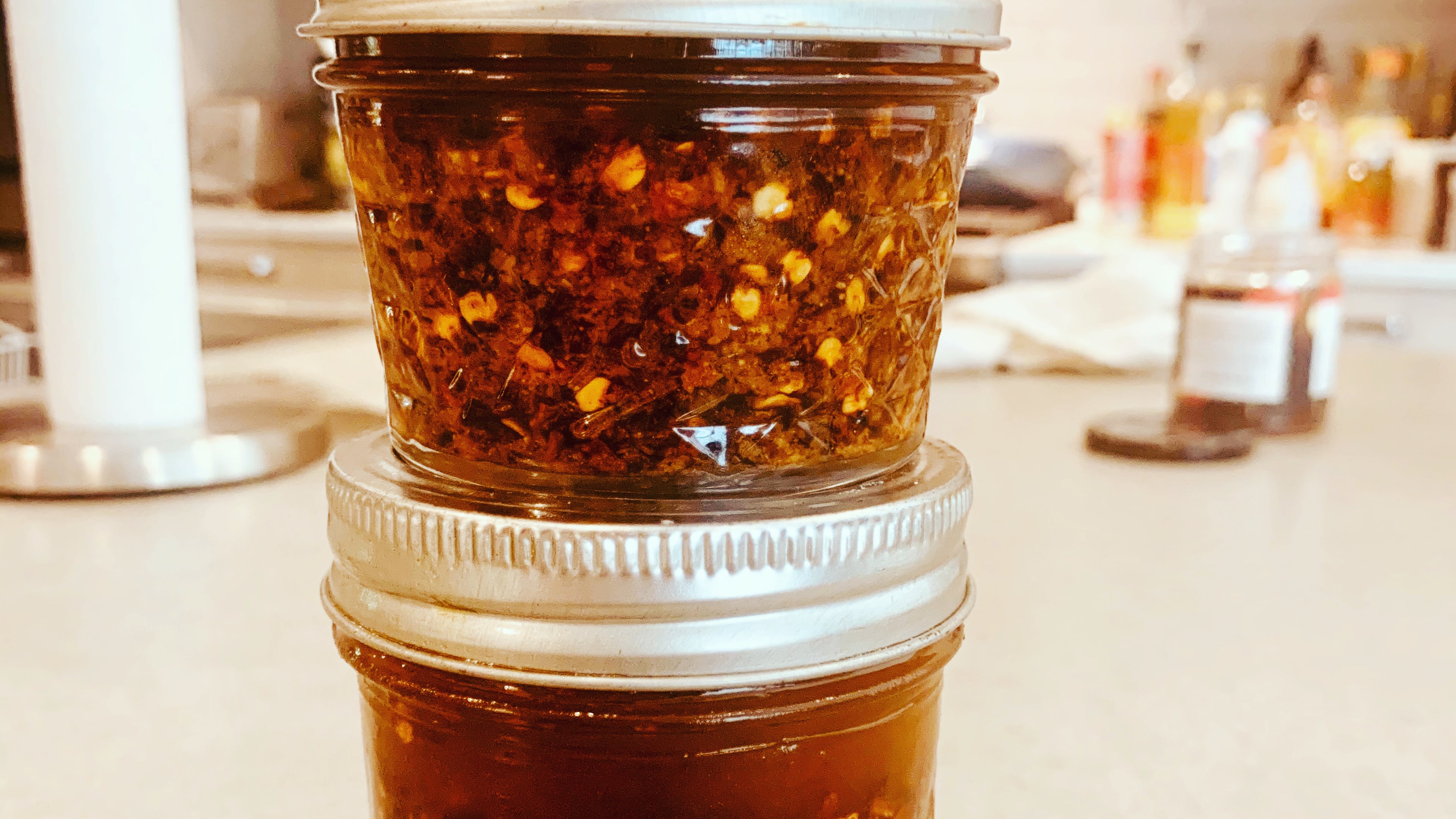 These are jars of prepared Spicy Chili Crisp, which you can make at home. John Kessler for The AJC