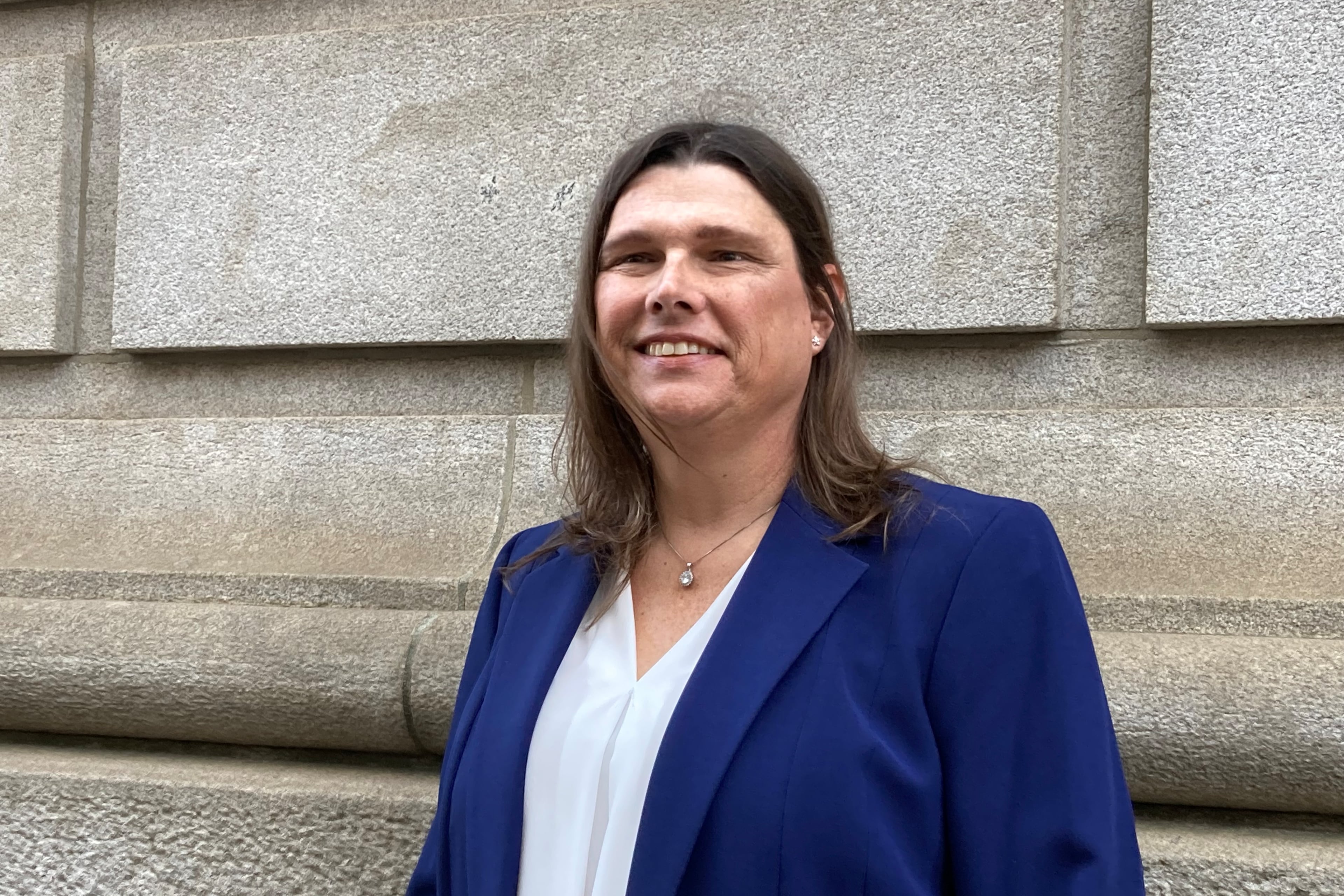 Sgt. Anna Lange, pictured outside the 11th Circuit courthouse in Atlanta in February 2025, has settled her landmark transgender rights case against Houston County and its sheriff. (Rosie Manins/AJC)