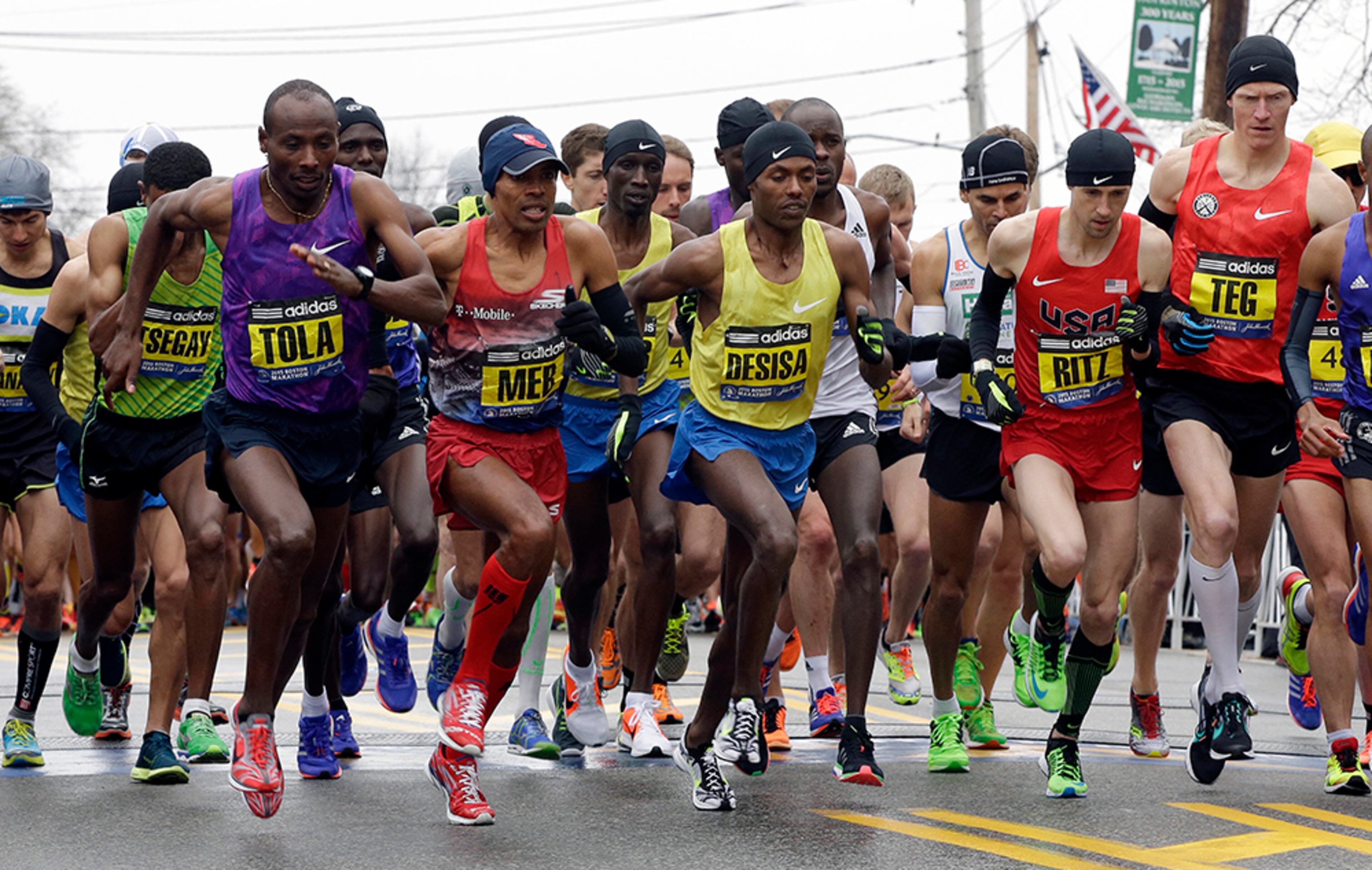 From left, Yemane Adhane Tsegay of Ethiopia, Tadese Tola of Ethiopia, Meb Keflezighi of San Diego, Lelisa Desisa of Ethiopia, Danthan Ritzenhein, of Rockford, Mich., and Matt Tegenkamp of Portland, Ore., leave the start line of the Boston Marathon Monday, April 20, 2015, in Hopkinton, Mass.