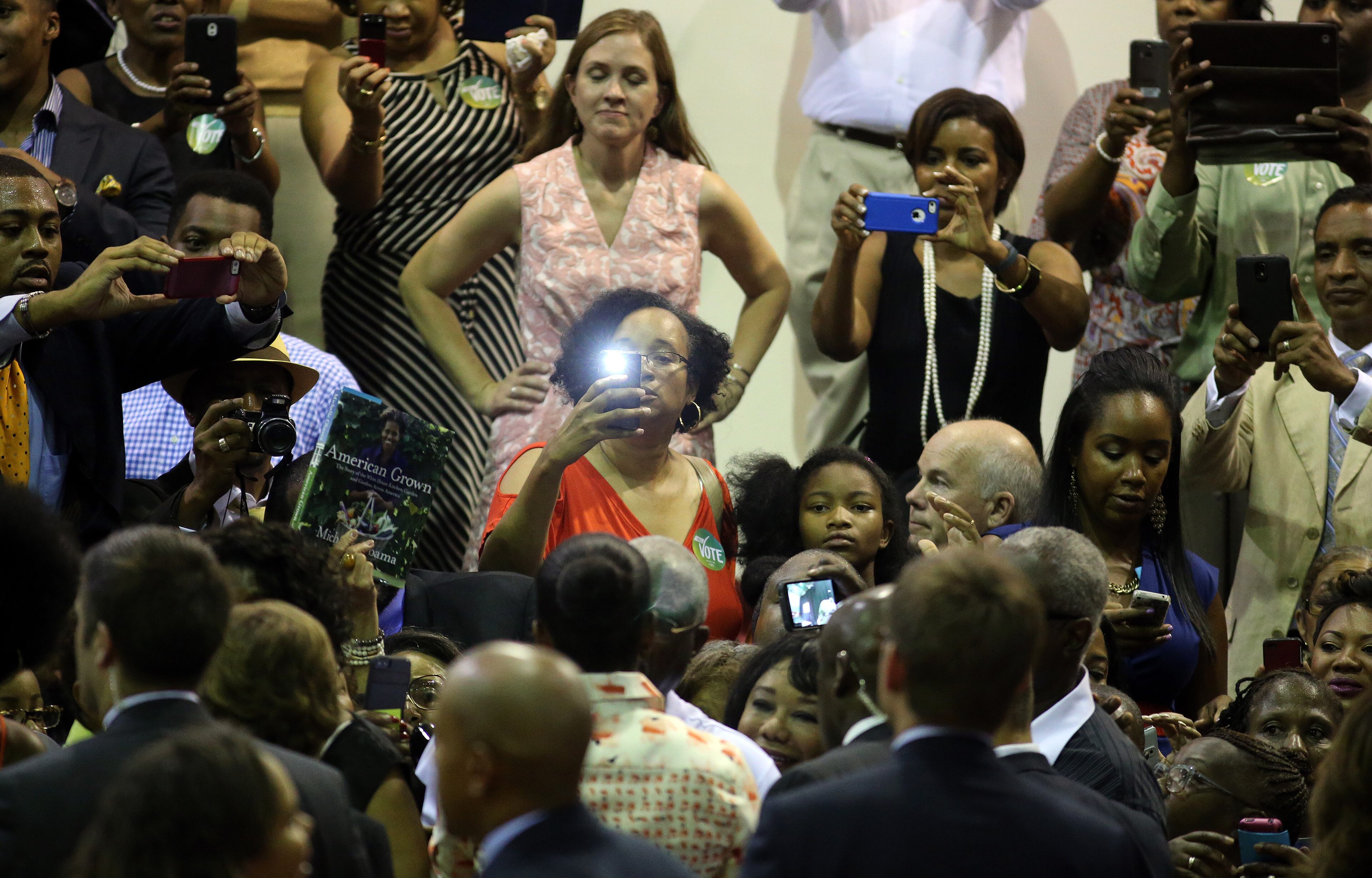 Supporters snap cell phone photos of First Lady Michelle Obama following a voter registration rally Monday evening Sept. 8, 2014, at the Martin Luther King Jr. Recreation Center in Atlanta. BEN GRAY / BGRAY@AJC.COM