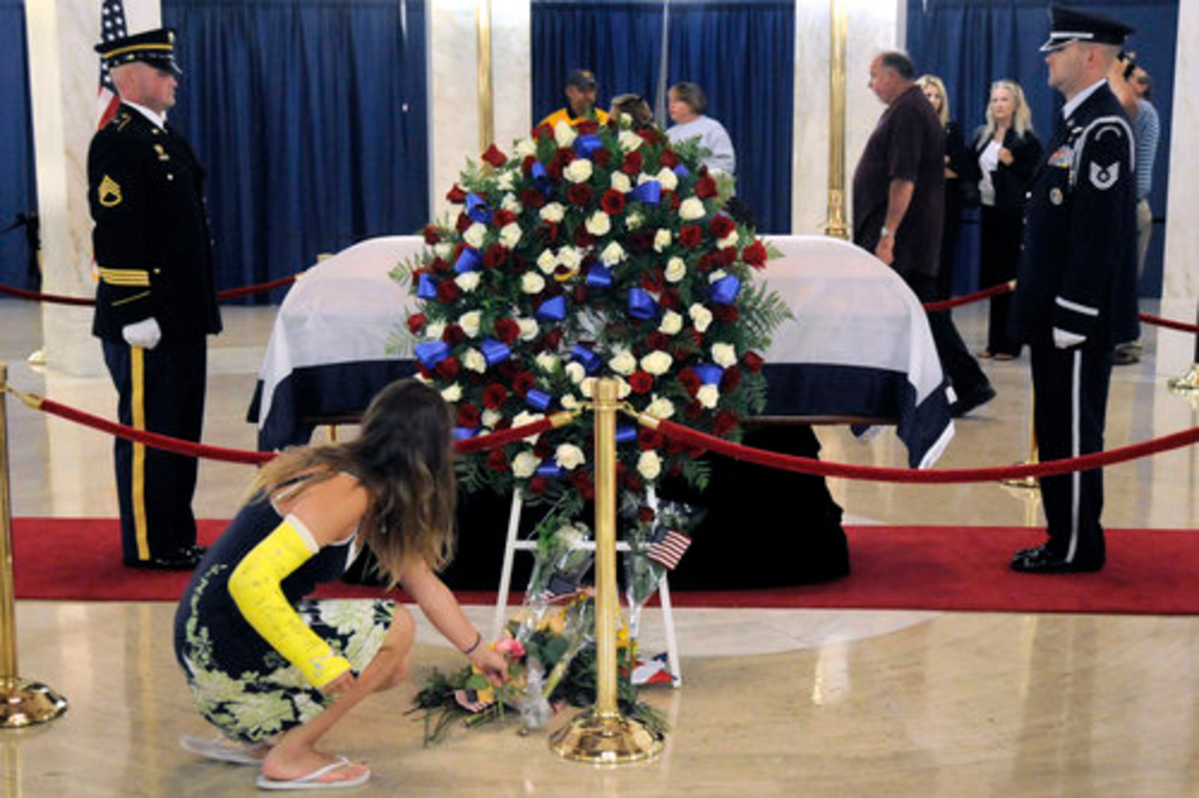 Grace Smiley, 16, of Cross Lanes, W.Va. lays a flower at the casket of Sen. Robert C. Byrd early Friday, July 1, 2010 in Charleston, W.Va.