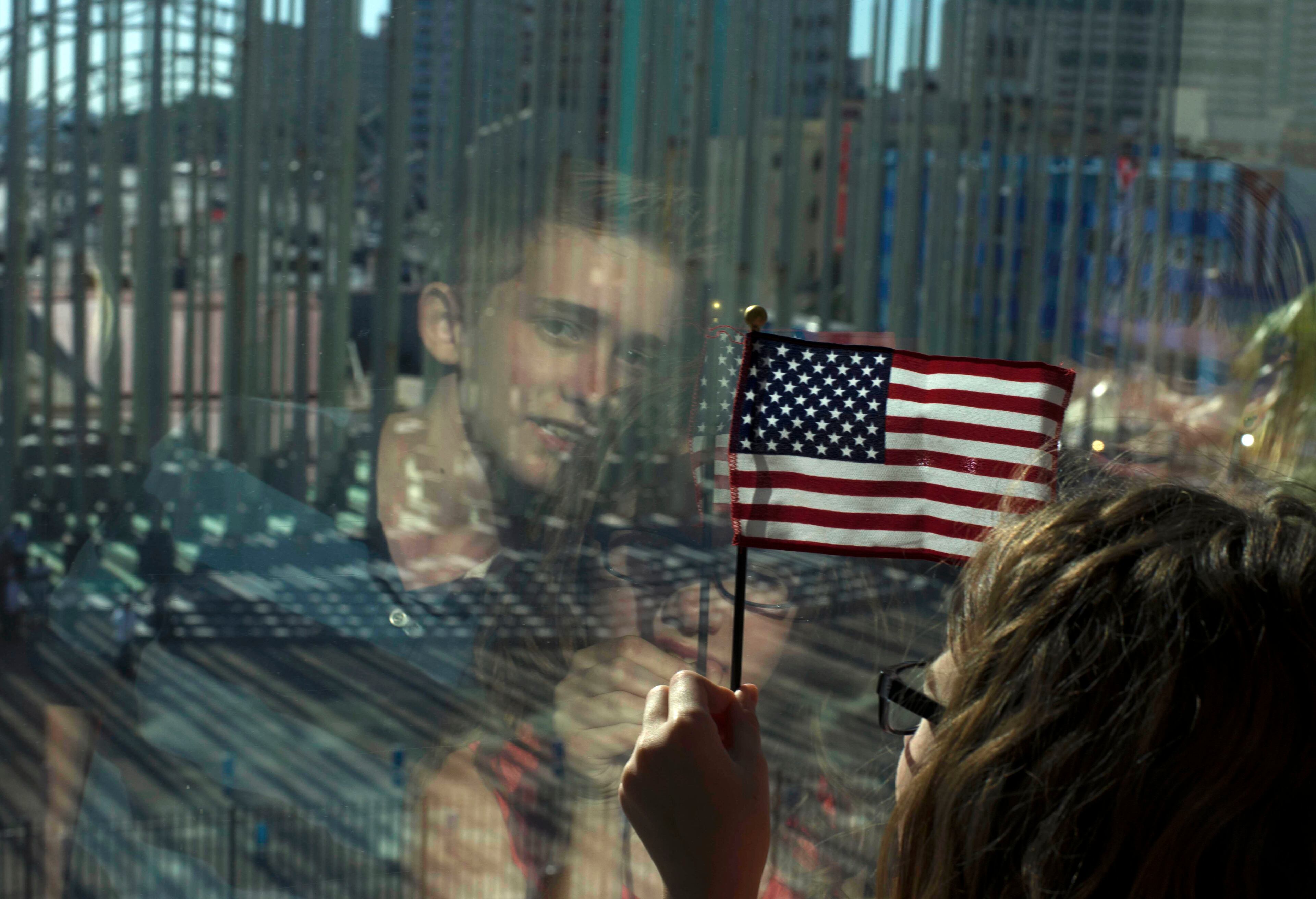 Family members of U.S. Embassy employees look out at the staging area before the start of a flag raising ceremony, at the newly opened U.S. Embassy, in Havana, Cuba, Friday, Aug. 14, 2015. Washington's top diplomat came to Havana on Friday to raise the Stars and Stripes over the newly opened embassy, making a symbolically charged victory lap for the Obama administration's new policy of engagement with Cuba. (AP Photo/Ramon Espinosa)