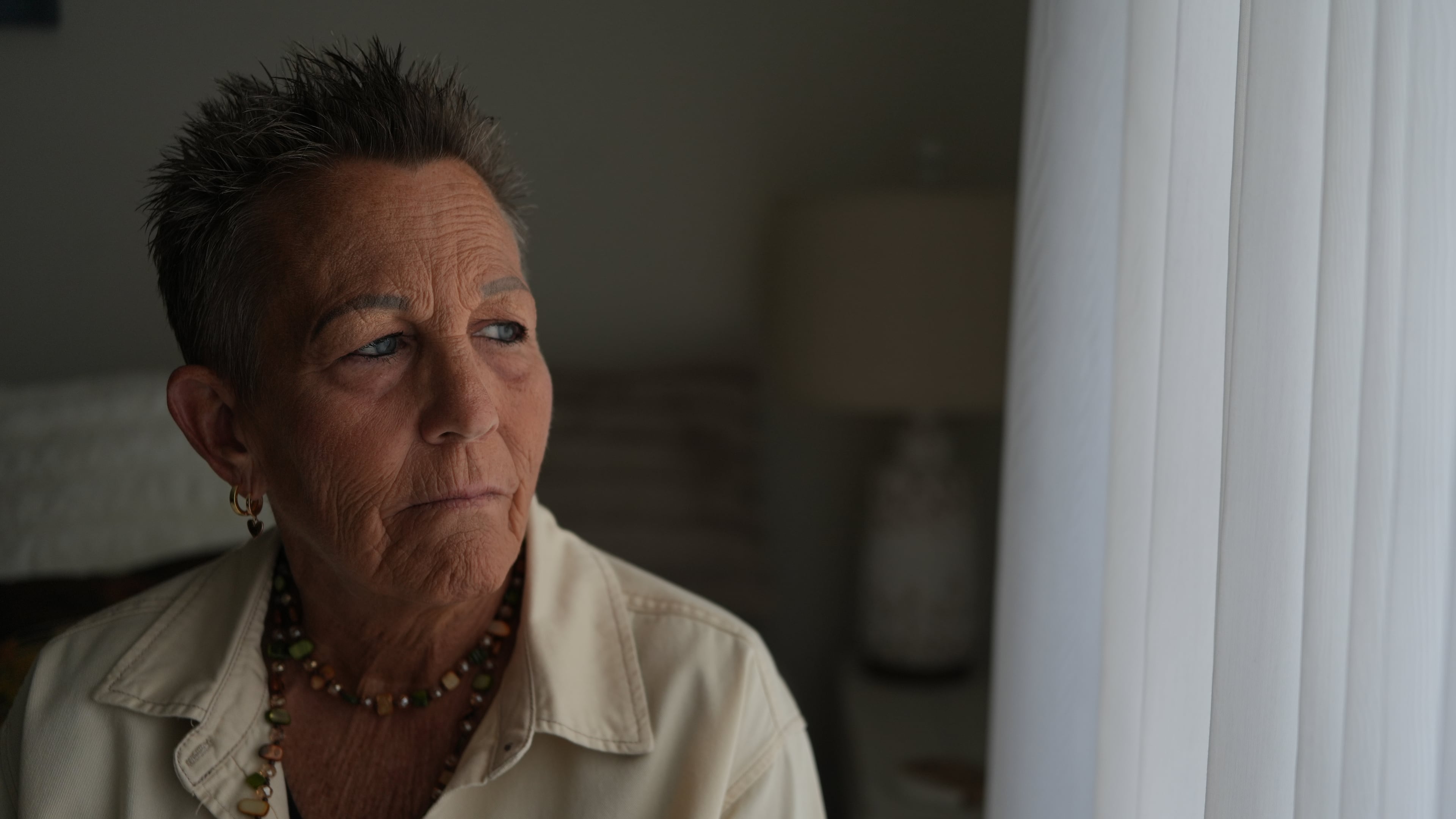 Deb Robertson, a leading advocate for a medical aid-in-dying law named after her in Illinois, pauses during an interview in her home in Lombard, Ill., on Tuesday, Sept. 8, 2026. (AP Photo/Luis Andres Henao)