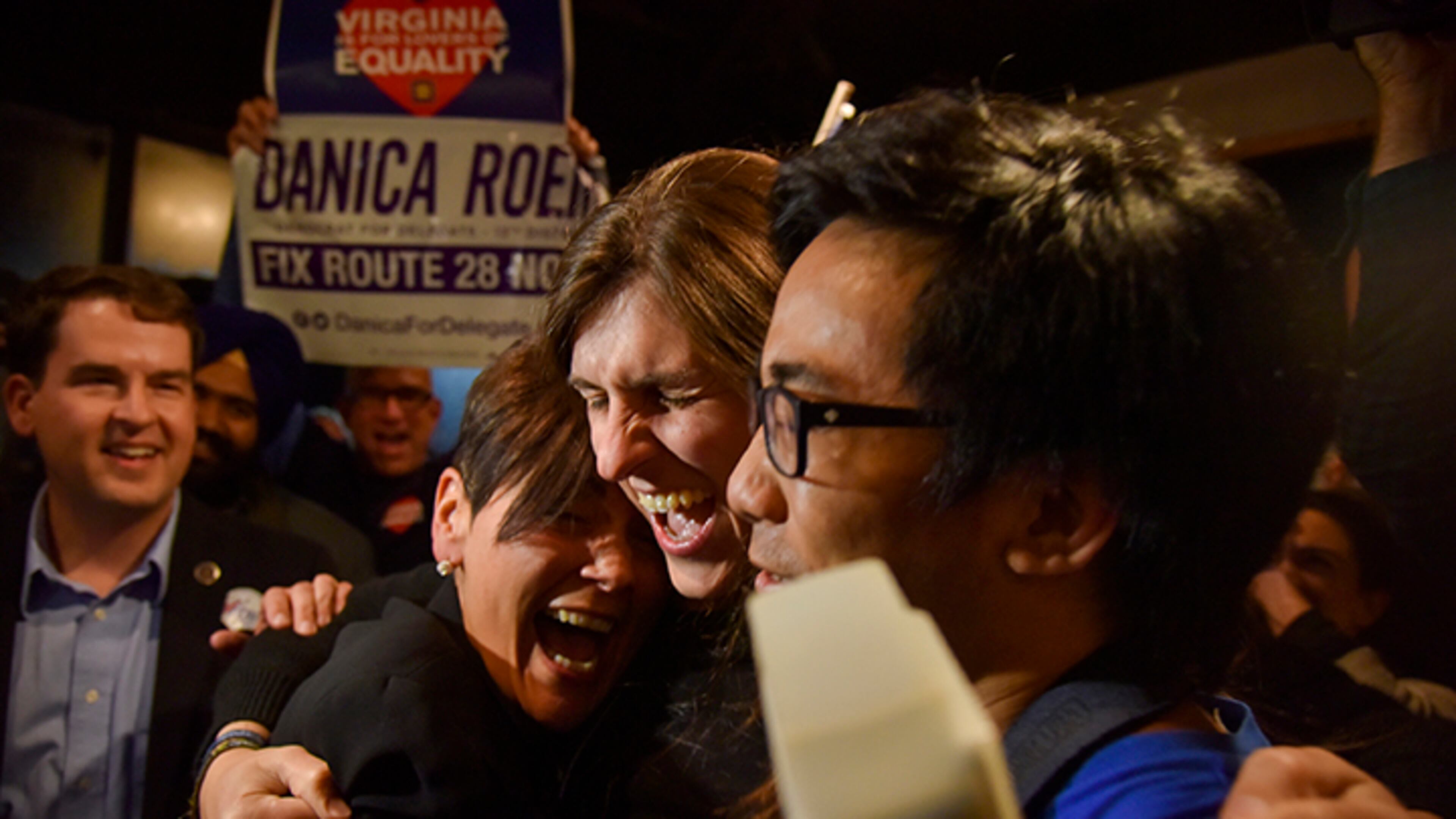 Danica Roem, center, a Democrat who ran for Virginia's House of Delegates against GOP incumbent Robert Marshall, is greeted by supporters as she prepares to give her victory speech Tuesday, Nov. 7, 2017, in Manassas, Va. Roem, a former journalist, is set to make history as the first openly transgender person elected and seated in a state legislature in the United States.