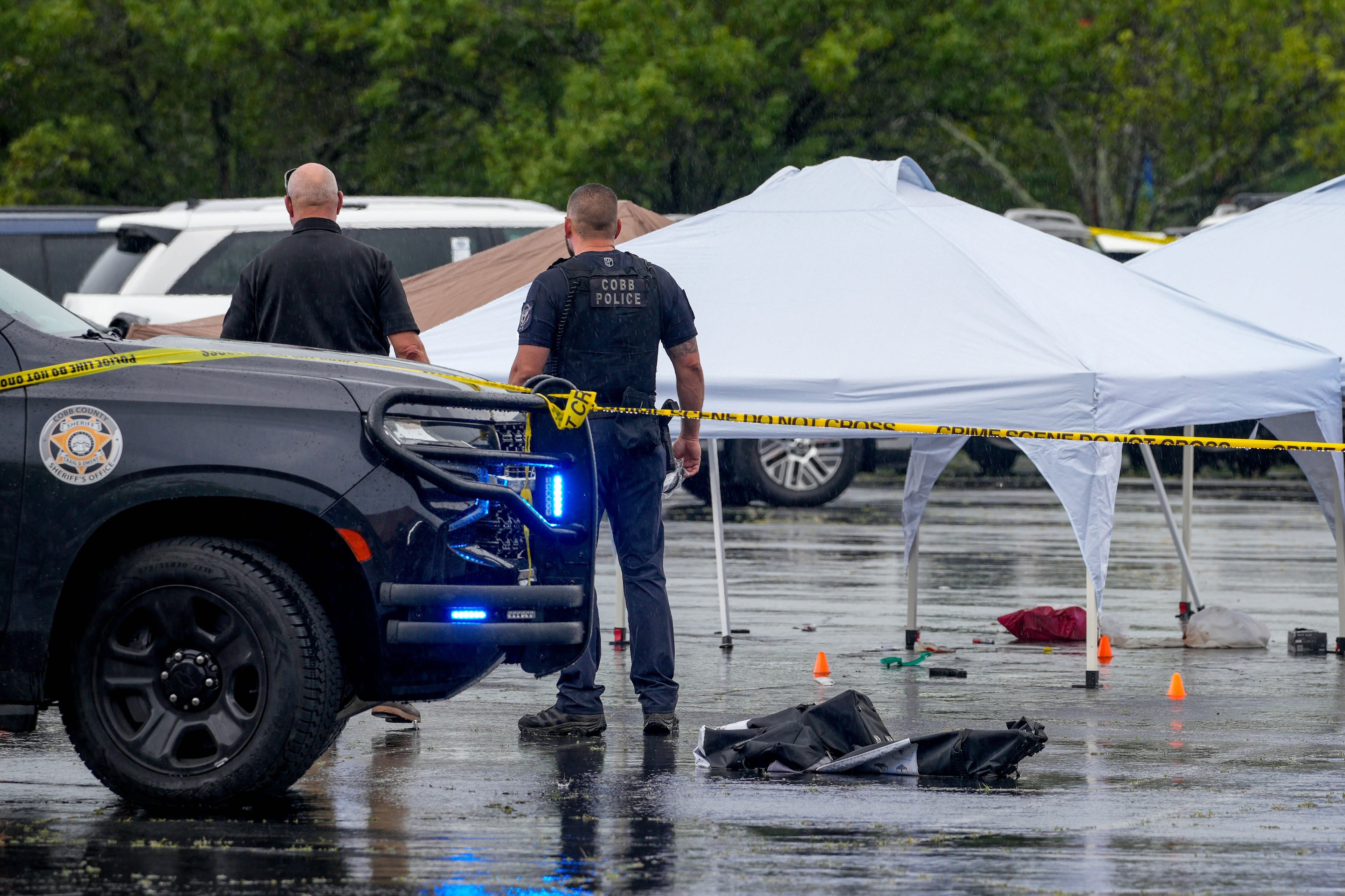 Rain began to pour as police responded after an officer-involved shooting incident at the Town Center at Cobb mall on Wednesday, May 27, 2026. (Ben Hendren for the AJC)