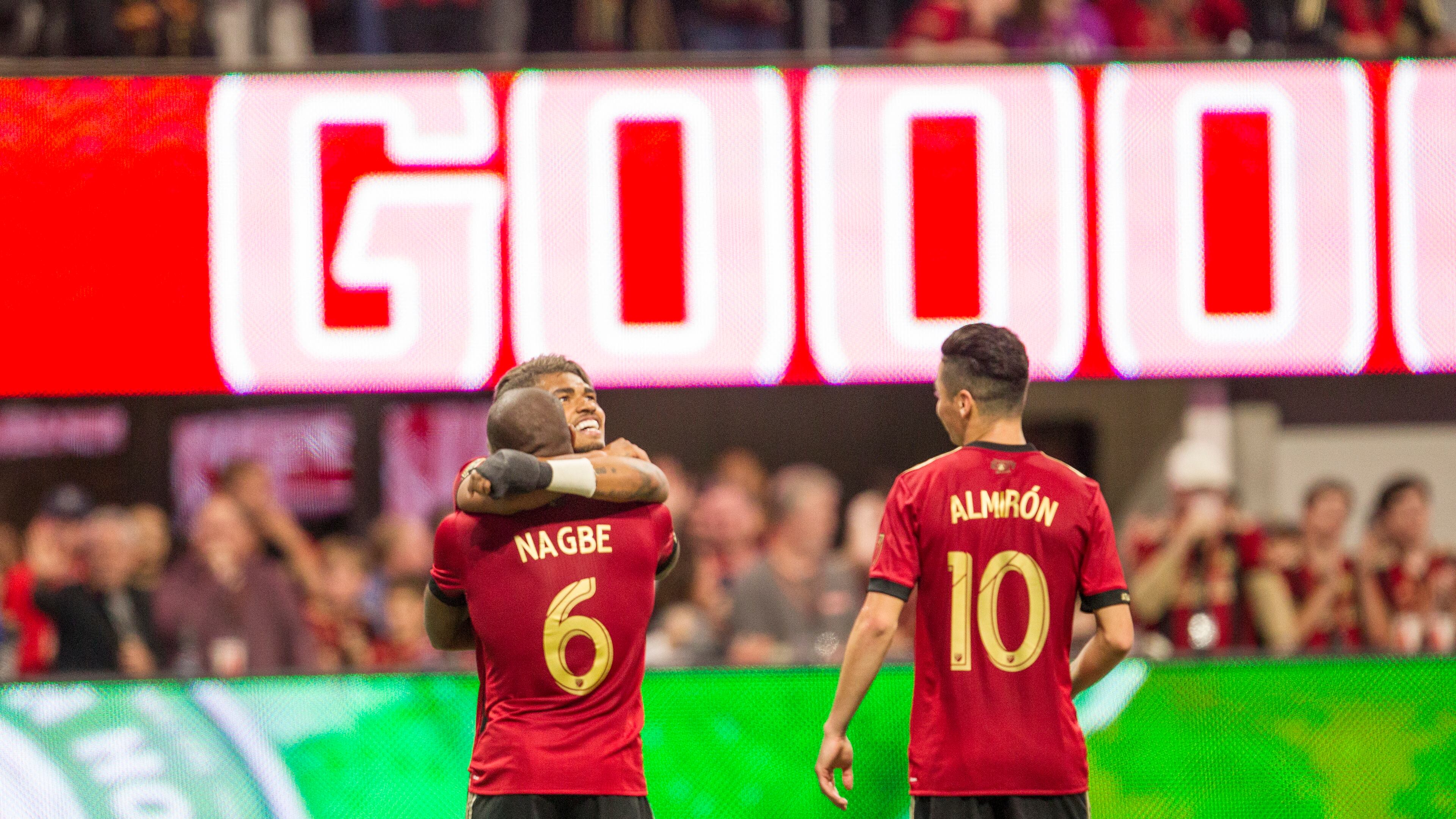 Atlanta United forward Josef Martinez (7) hugs Atlanta United midfielder Darlington Nagbe (6) after Nagbe makes a goal during the match between NYC FC and Atlanta United at Mercedes-Benz Stadium in Atlanta, Georgia, on Sunday, April 15, 2018. The goal was later taken away due to a penalty. (REANN HUBER/REANN.HUBER@AJC.COM)
