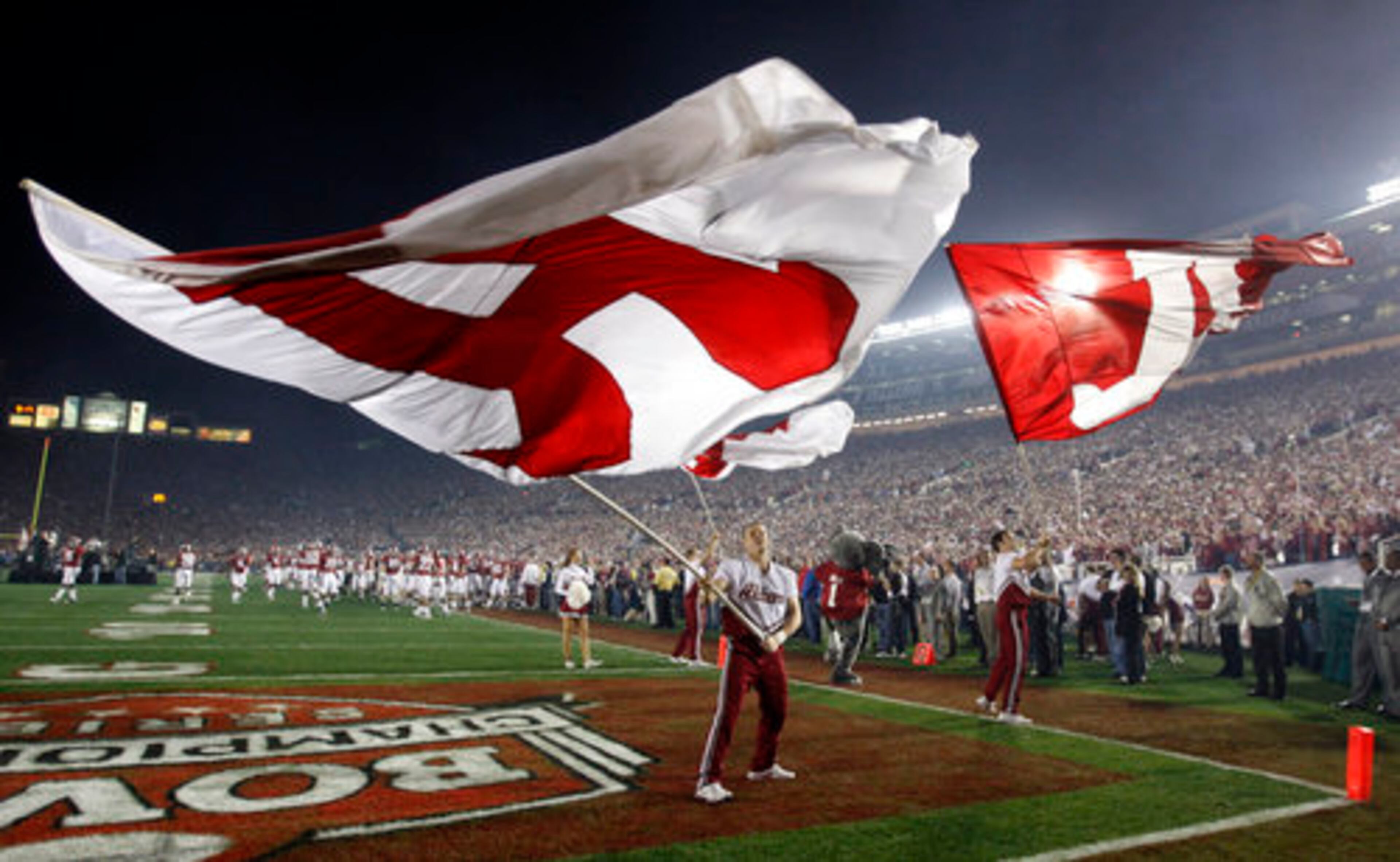 Alabama cheerleaders wave banners before the game.
