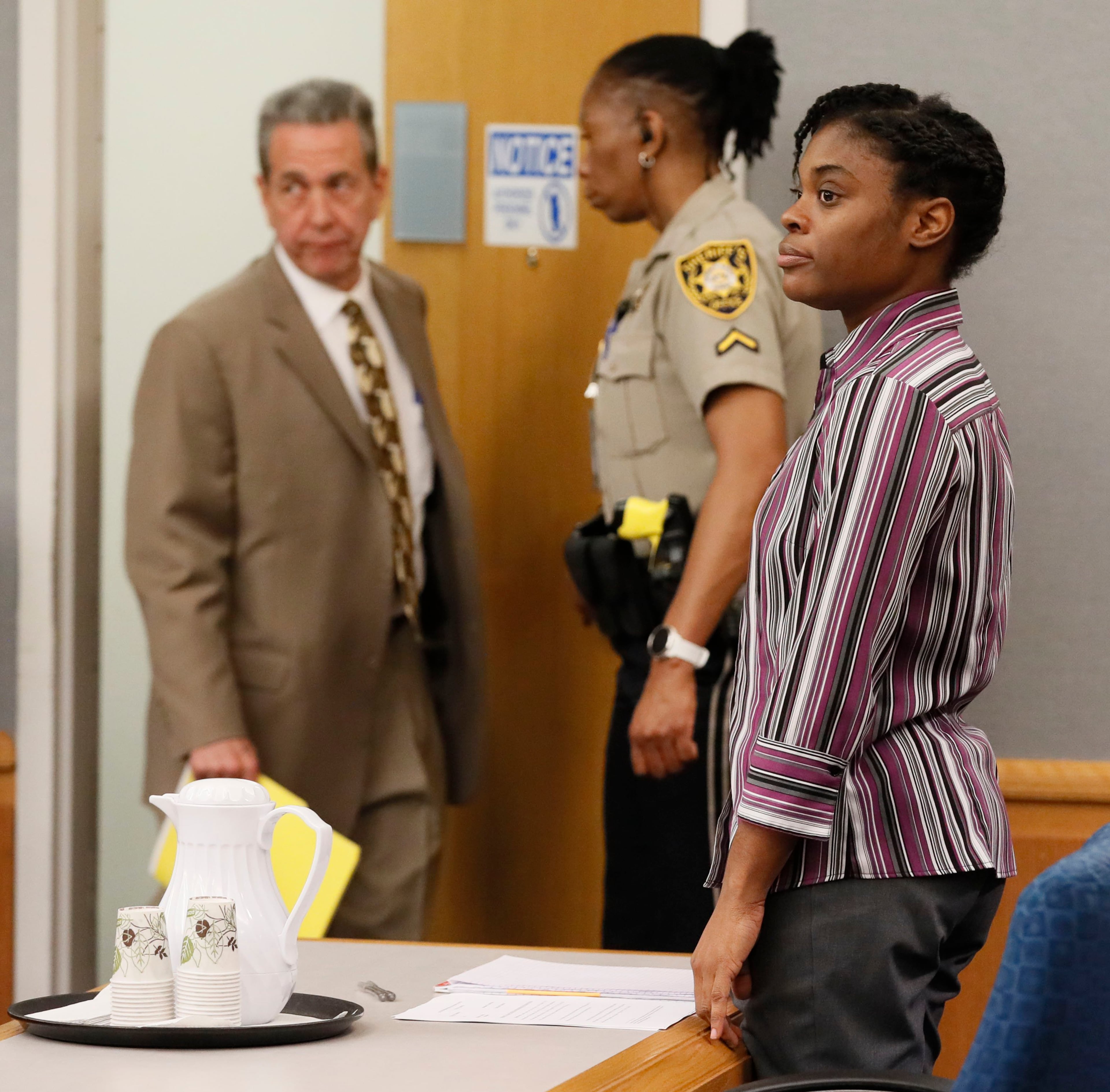 April 25, 2019 - Lawrenceville - Tiffany Moss stands as she waits for the jury to be seated as District Attorney Danny Porter enters (left). The prosecution continued for the second day in the Tiffany Moss death penalty trial with the testimony of Eman Moss. Moss, who is representing herself, again declined to ask questions of the prosecution witnesses. Bob Andres / bandres@ajc.com