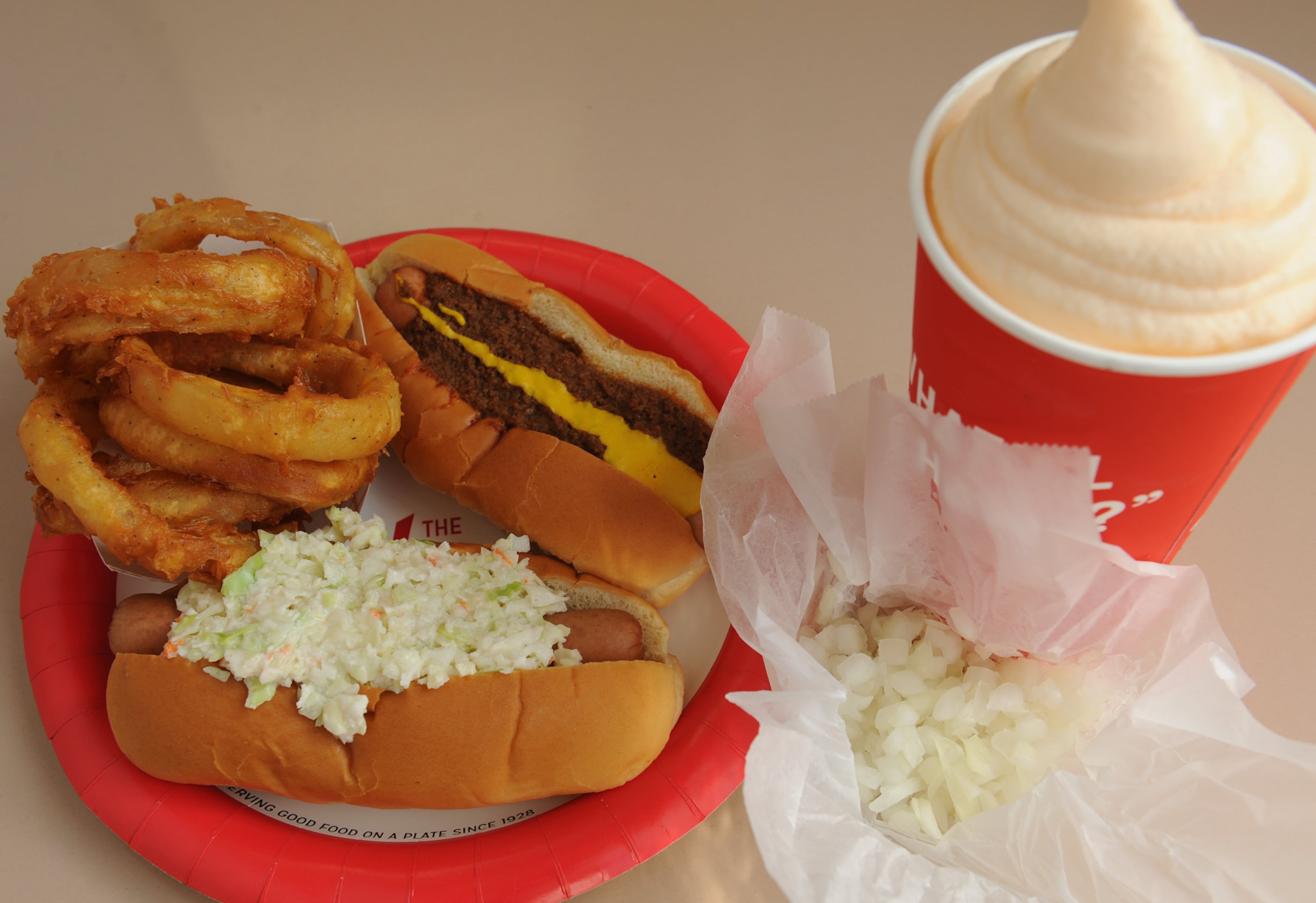 151013-ATLANTA-GA- Wendell Brock reports on the Varsity and its history of food and scene in Atlanta on Tuesday October 13, 2015. FOOD: Frosted orange, chopped onions, slaw dog, chili cheese dog and rings.(Becky Stein Photography)