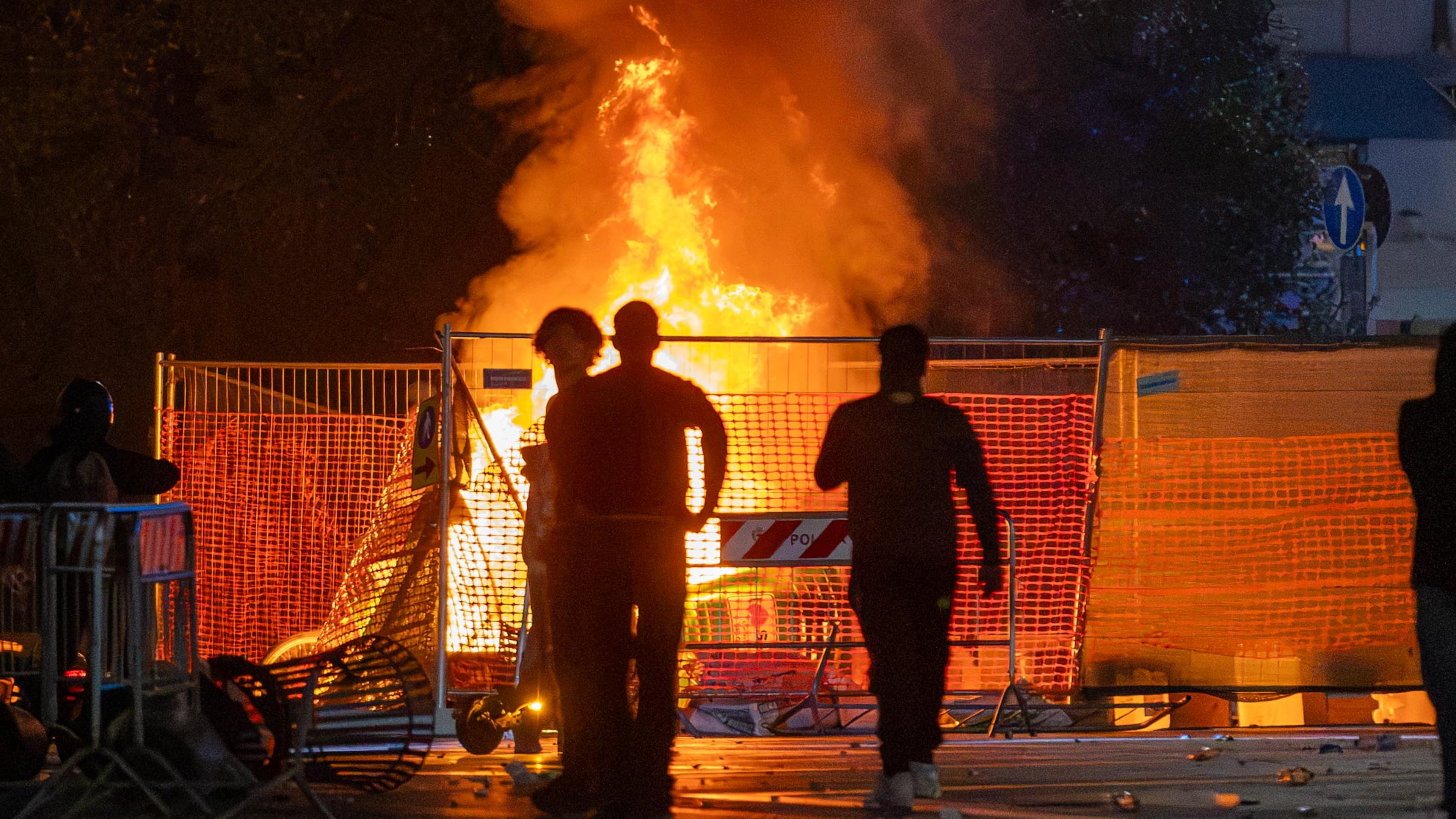 A fire burns following clashes between police and "Italia in Piazza" protesters in front of the Milan Cathedral in Milan, Italy, on Saturday, Oct. 17, 2026. (Stefano Porta/LaPresse via AP)