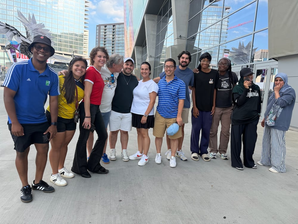 Atlanta sports marketer Vince Thompson (fourth from left) with a group of family, friends, associates and members of the Soccer in the Streets community pose for a photo at the Haiti-Morocco World Cup game. (Photo courtesy Vince Thompson)
