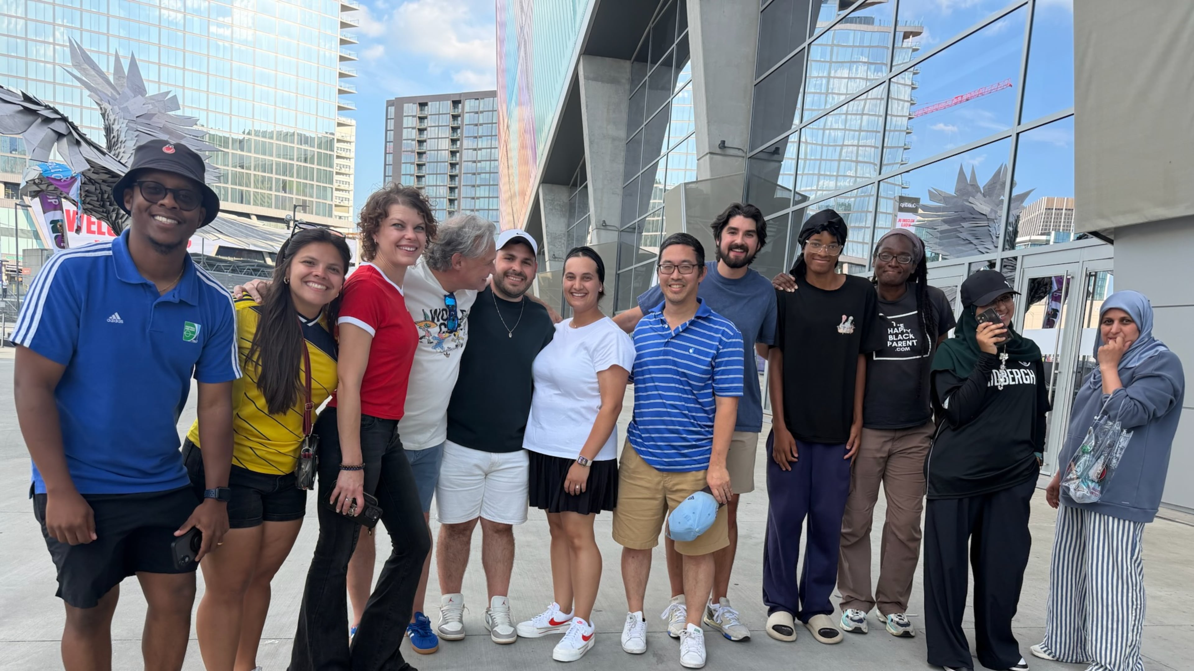 Atlanta sports marketer Vince Thompson (fourth from left) with a group of family, friends, associates, members of the Soccer in the Streets community and an AJC writer pose for a photo outside Mercedes-Benz Stadium at the Haiti-Morocco World Cup game June 24, 2026. (Photo courtesy of Vince Thompson)