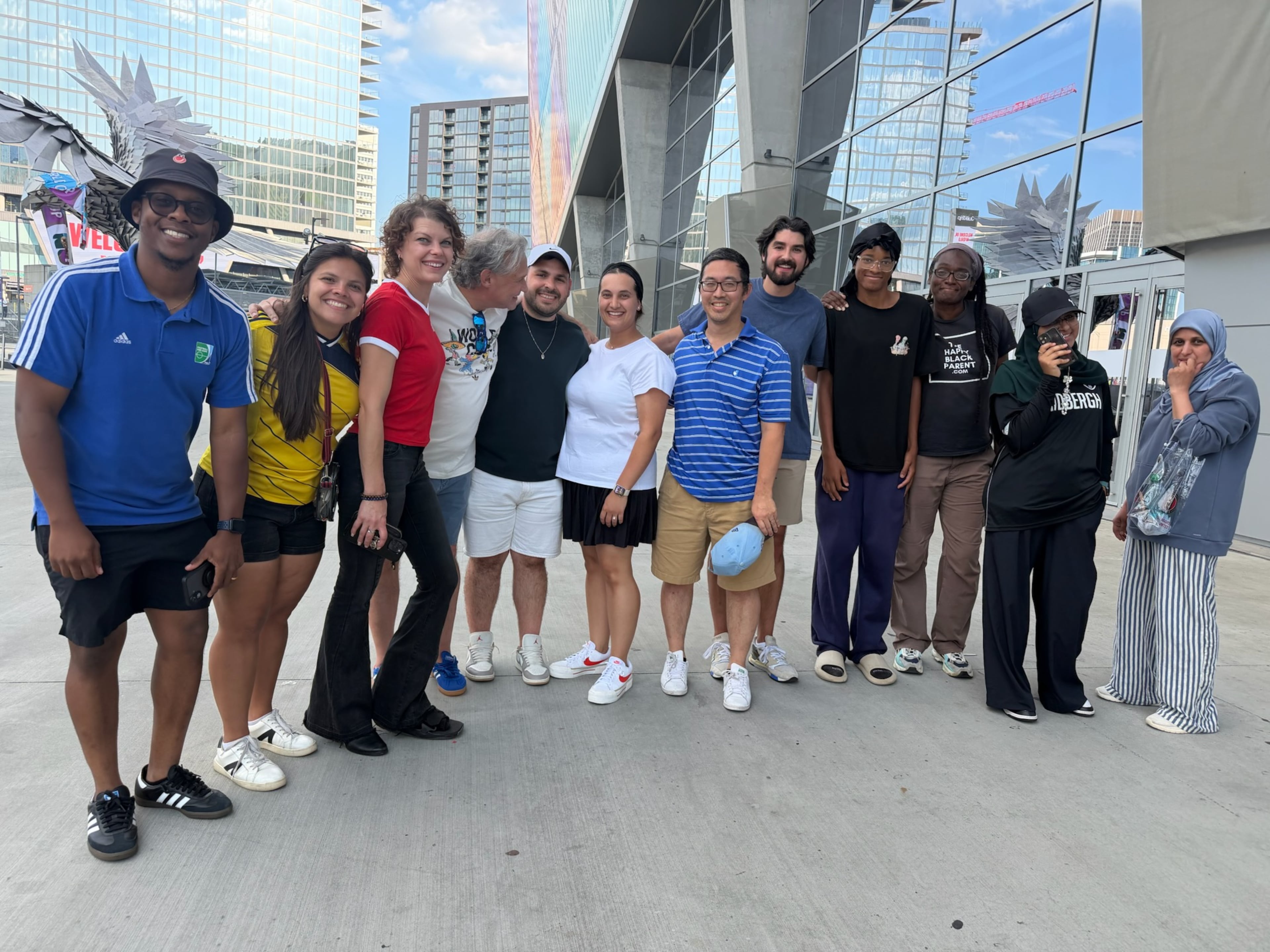Atlanta sports marketer Vince Thompson (fourth from left) with a group of family, friends, associates and members of the Soccer in the Streets community pose for a photo at the Haiti-Morocco World Cup game. (Photo courtesy Vince Thompson)