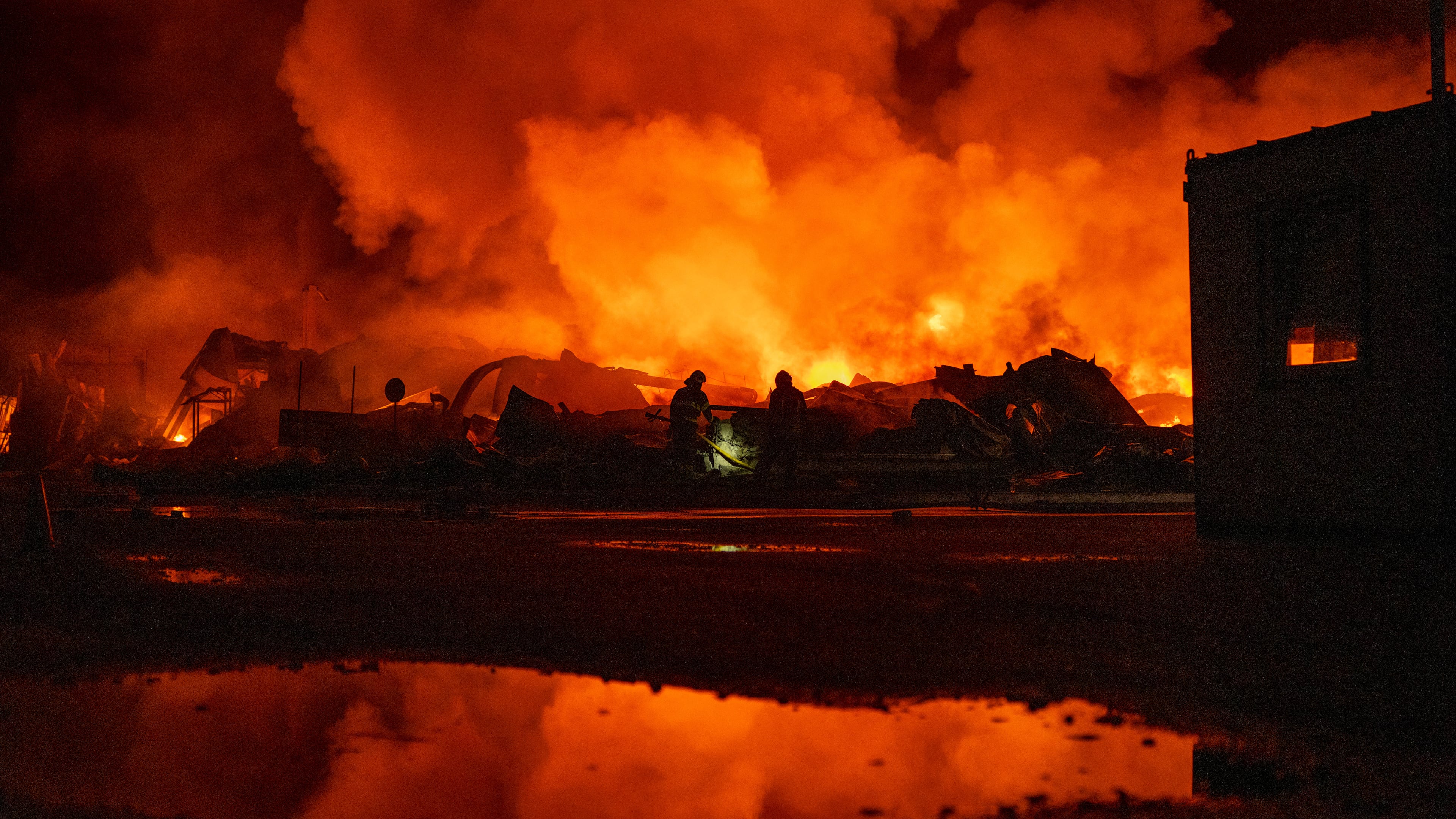 Firefighters put out a fire after Russian missiles hit a warehouse in Kyiv, Ukraine, Wednesday, Aug. 5, 2026. (AP Photo/Dan Bashakov)