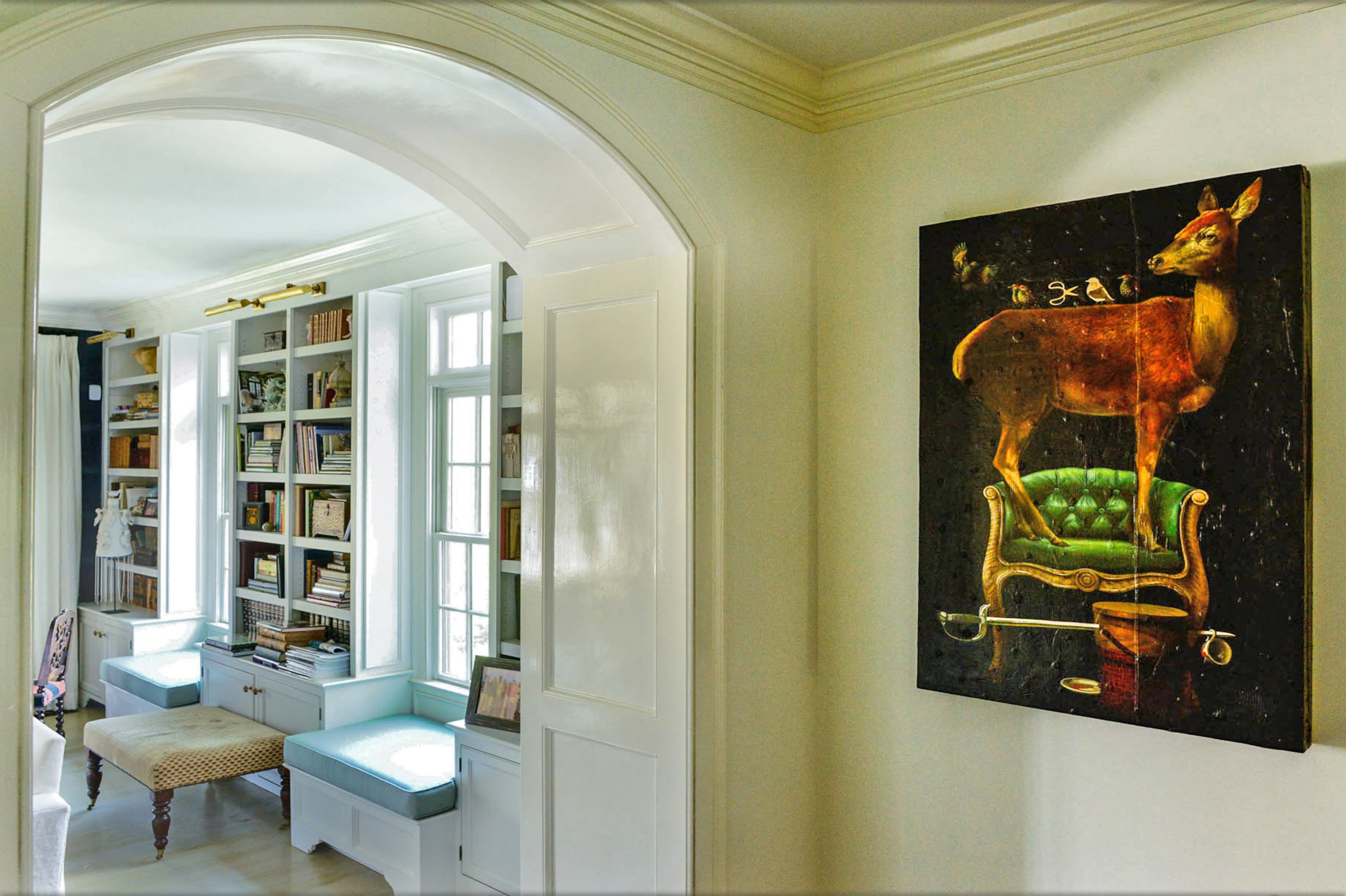 A painting of a deer on a green couch by O. M. Norling deserves a second look in the foyer. A series of arches, added during the renovation by previous owners, lead to rooms such as the family room.