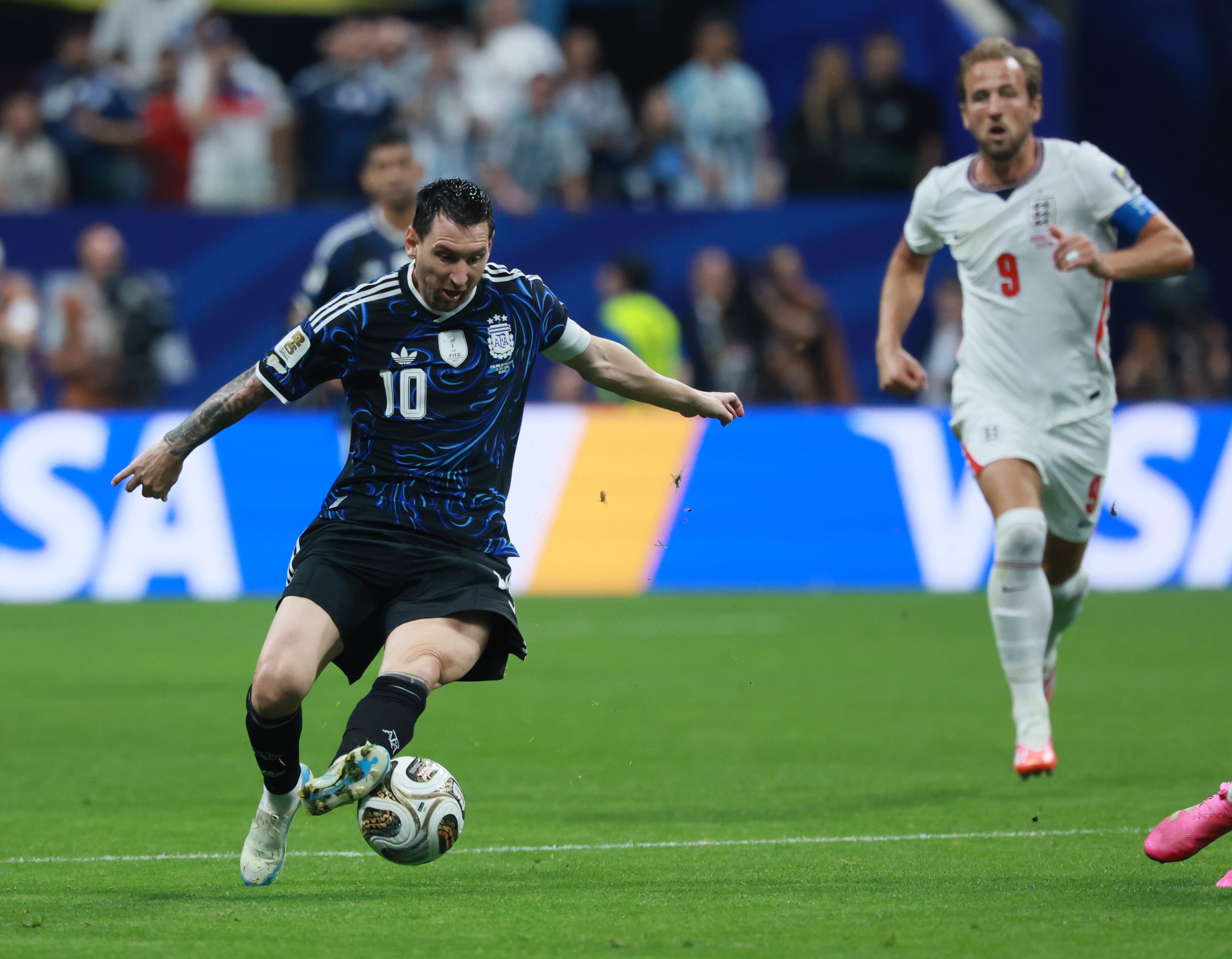 Argentina's Lionel Messi controls the ball as England's Harry Kane gives chase during first half of Argentina vs. England FIFA World Cup Semifinal match at Atlanta Stadium (Mercedes-Benz Stadium) on Wednesday, July 15, 2026. (Jason Getz/AJC)
