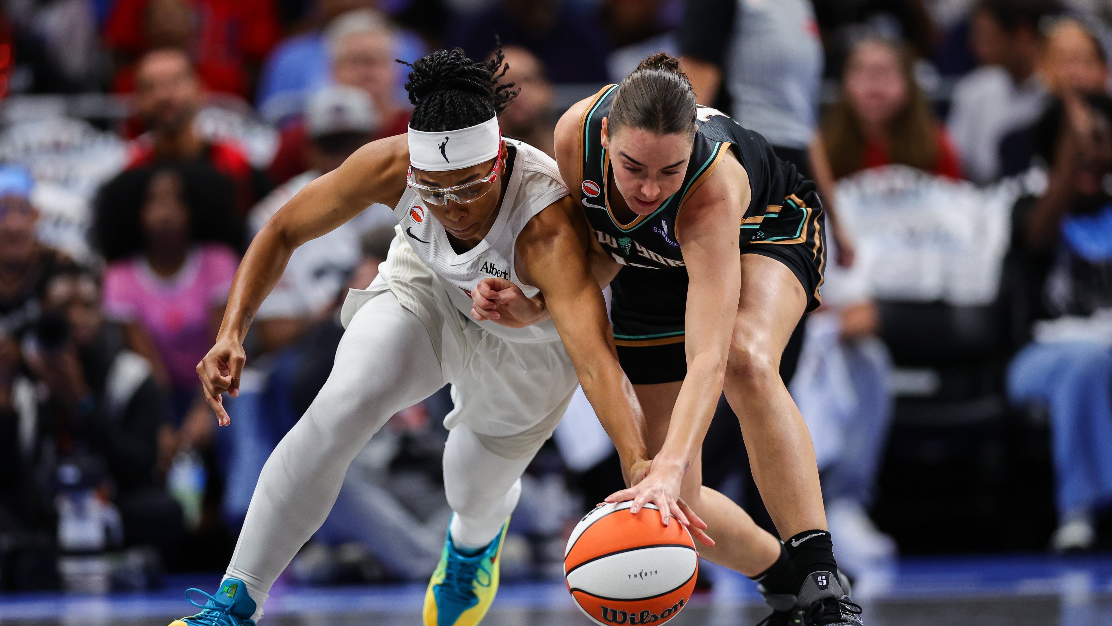 Atlanta Dream guard Allisha Gray, left, fights for possession with New York Liberty guard Pauline Astier, right, during the first half of Game 1 of the WNBA basketball semifinals Sunday, Oct, 4, 2026, in Atlanta. (AP Photo/Colin Hubbard)