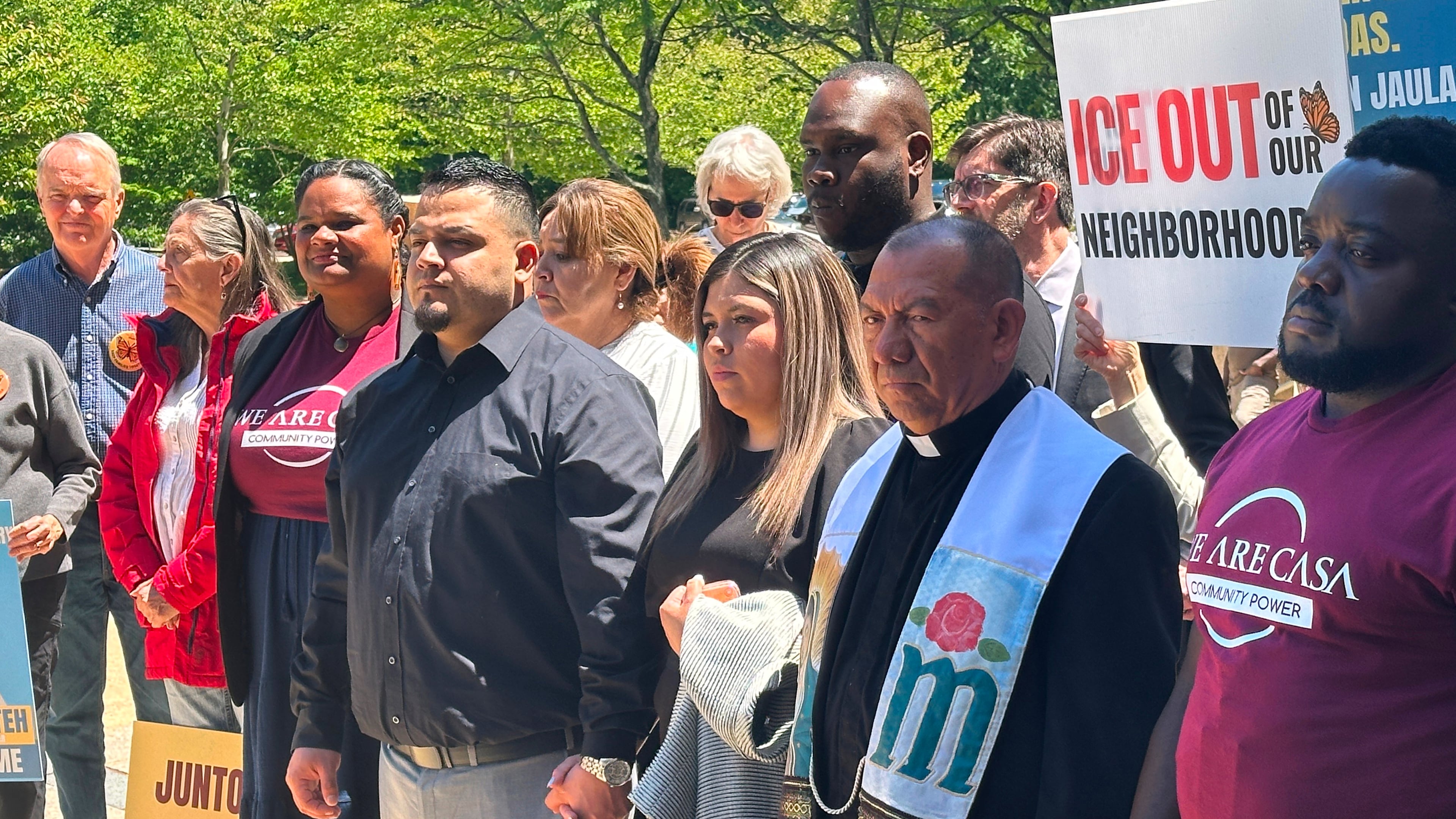 Kilmar Abrego Garcia and his wife, center, hold hands as people rally in support of him at a news conference outside federal court after a hearing in his case on Tuesday, May 12, 2026, in Greenbelt, Md. (AP Photo/Michael Kunzelman)