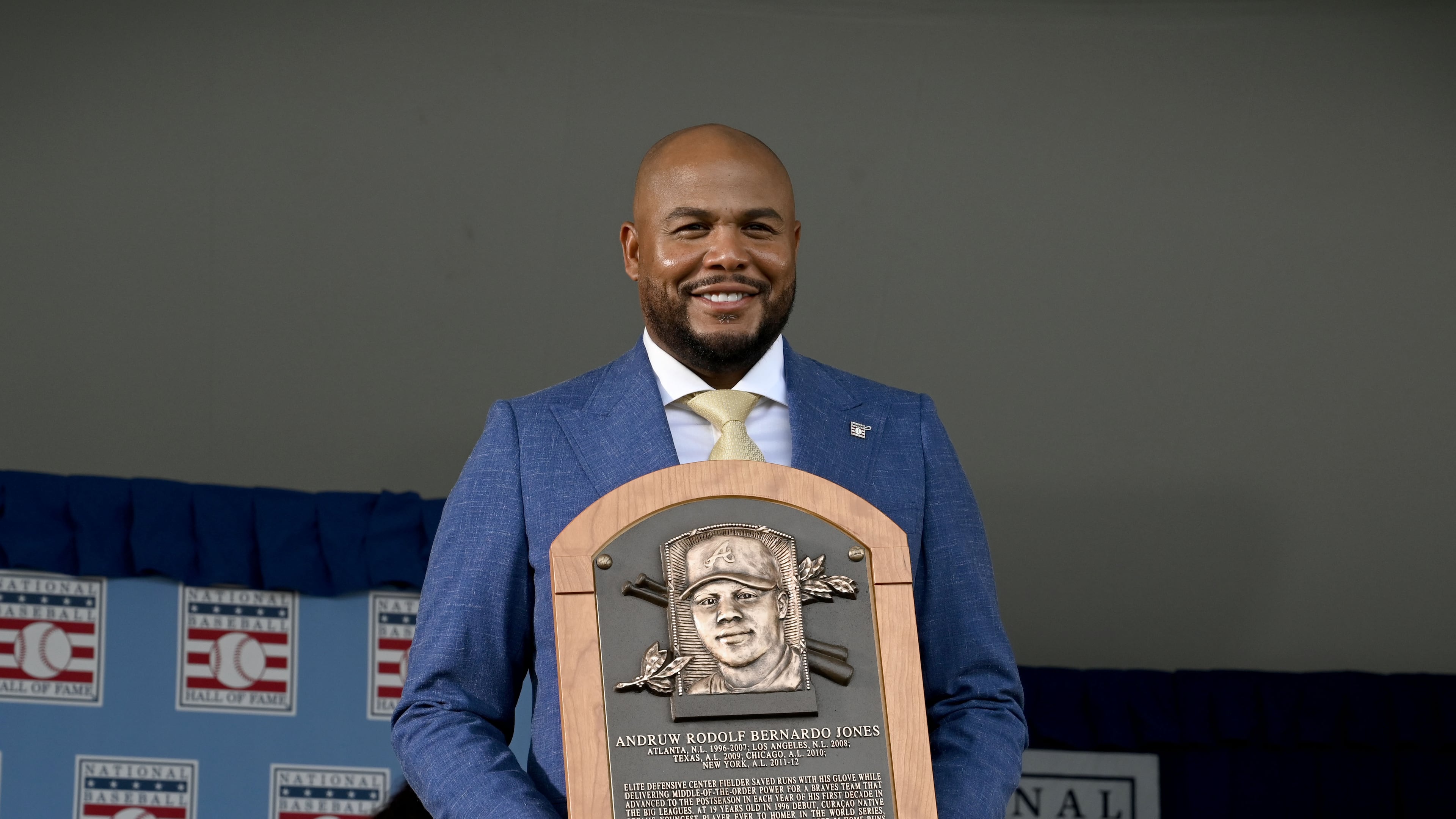 Andruw Jones poses with his Hall of Fame plaque during the National Baseball Hall of Fame induction ceremony at the Clark Sports Center on Sunday, July 26, 2026, in Cooperstown, N.Y. The Braves center fielder Andruw Jones was inducted alongside Carlos Beltrán and Jeff Kent. (Hyosub Shin/AJC)