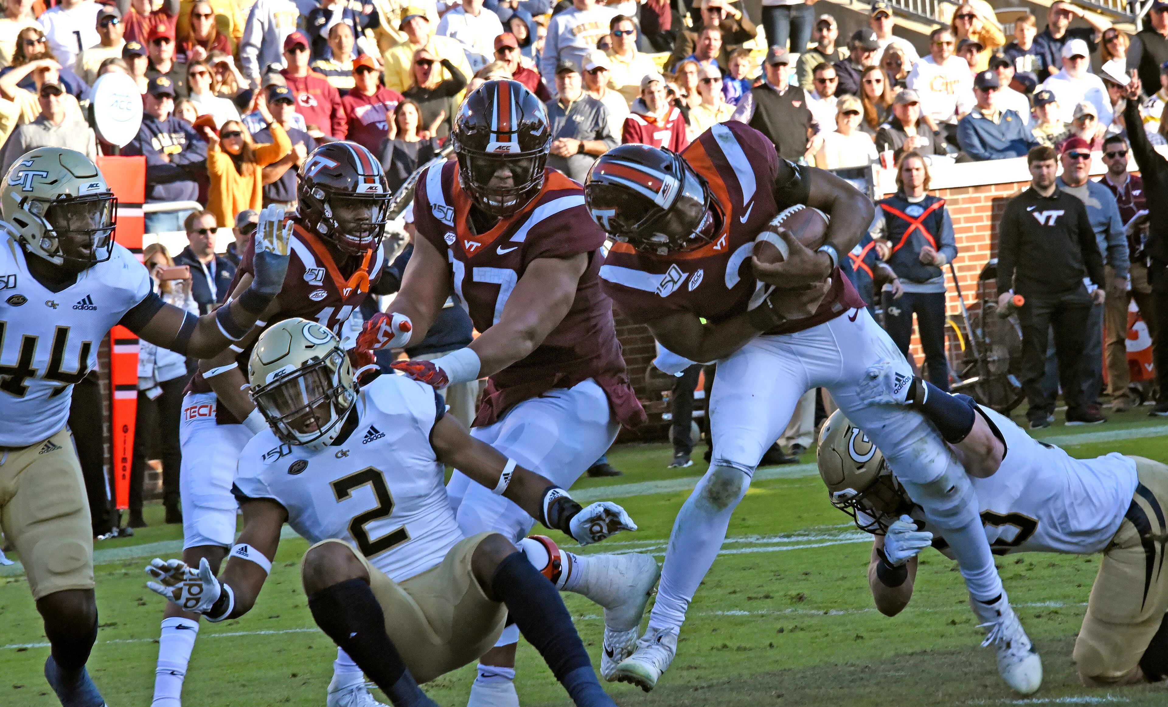 Virginia Tech quarterback Hendon Hooker (2) eludes a tackle by Georgia Tech defensive lineman Brandon Adams (90) and scores a touchdown during the first half of an NCAA college football game at Bobby Dodd Stadium on Saturday, November 16, 2019. (Hyosub Shin / Hyosub.Shin@ajc.com)