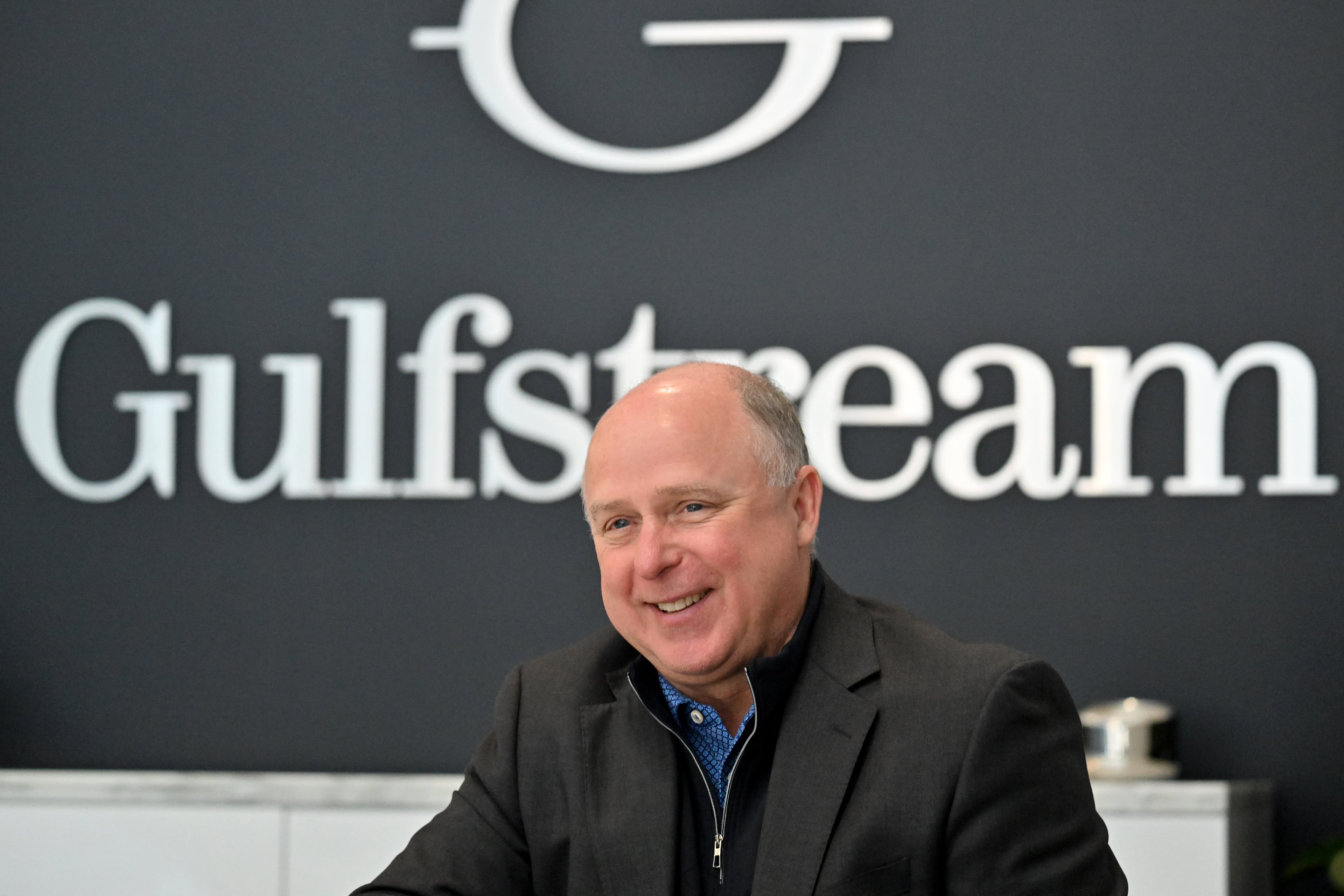 Scott Neal, senior vice president of Worldwide Sales, speaks to a visitor at Gulfstream Aerospace Corporation’s showroom on Friday, December 19, 2025, in Savannah. (Hyosub Shin/AJC)