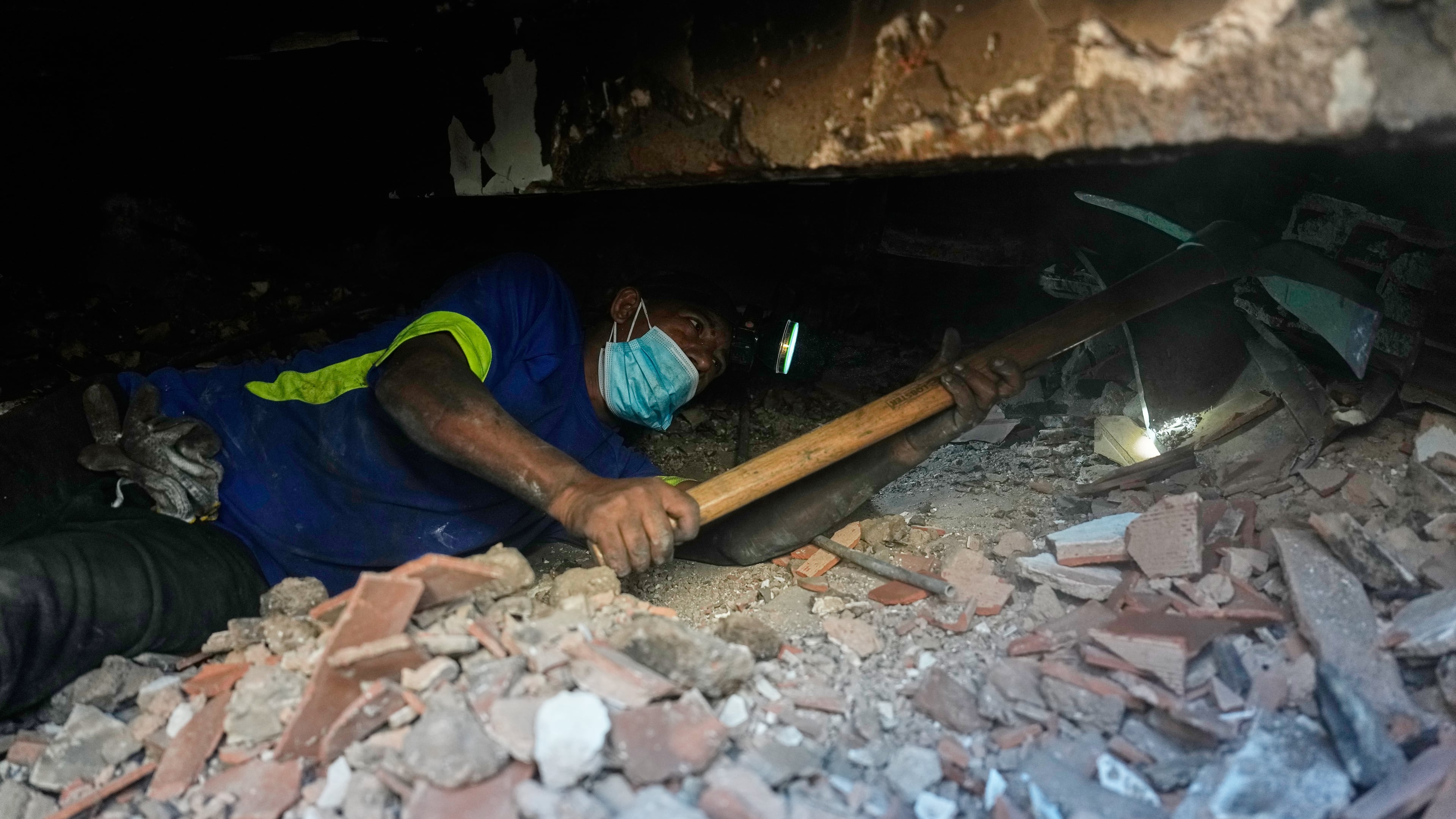Franklin Rodriguez searches for missing relatives in the rubble of his apartment building, which collapsed in the back-to-back earthquakes that struck La Guaira, Venezuela, Monday, June 29, 2026. (AP Photo/Fernando Vergara)