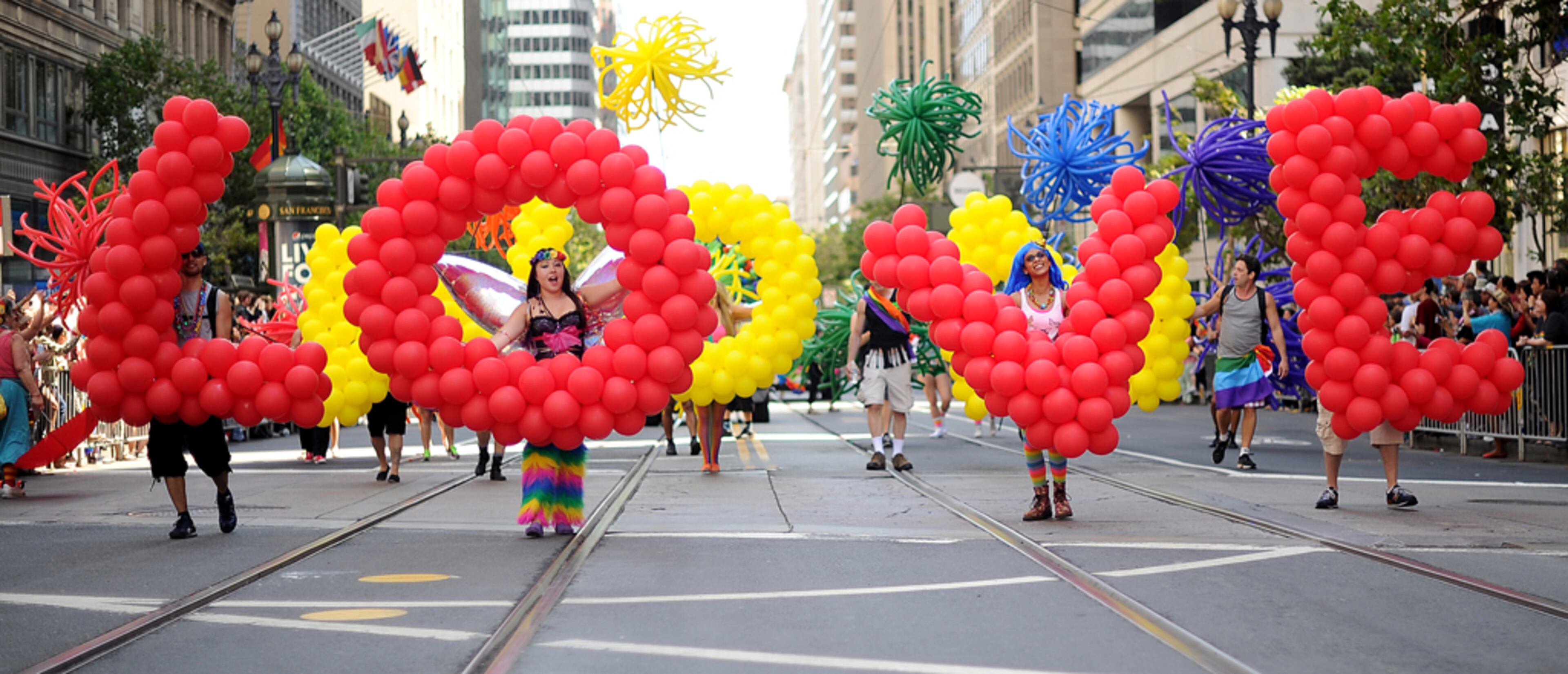 Deanna Ryan carries the letter "O" as part of a balloon brigade spelling "love" during San Francisco's 43rd annual Gay Pride parade on Sunday, June 30, 2013. (AP Photo/Noah Berger)