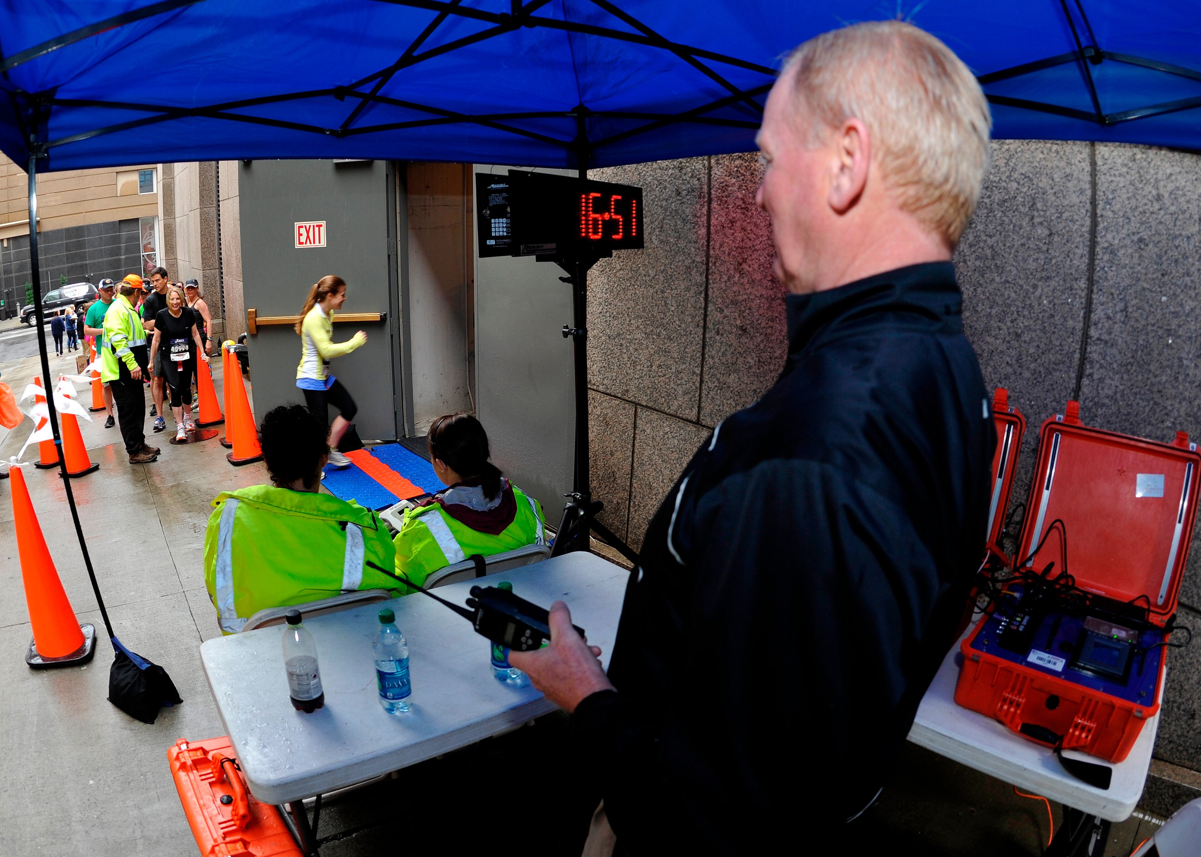 Racing Solutions' Skip Breeser, right, and his timing team pace participants as over 600 stair climbers race to the top of One Ninety One Peachtree Tower at the American Lung Association's Fight for Air Climb on Saturday, April 19, 2014.