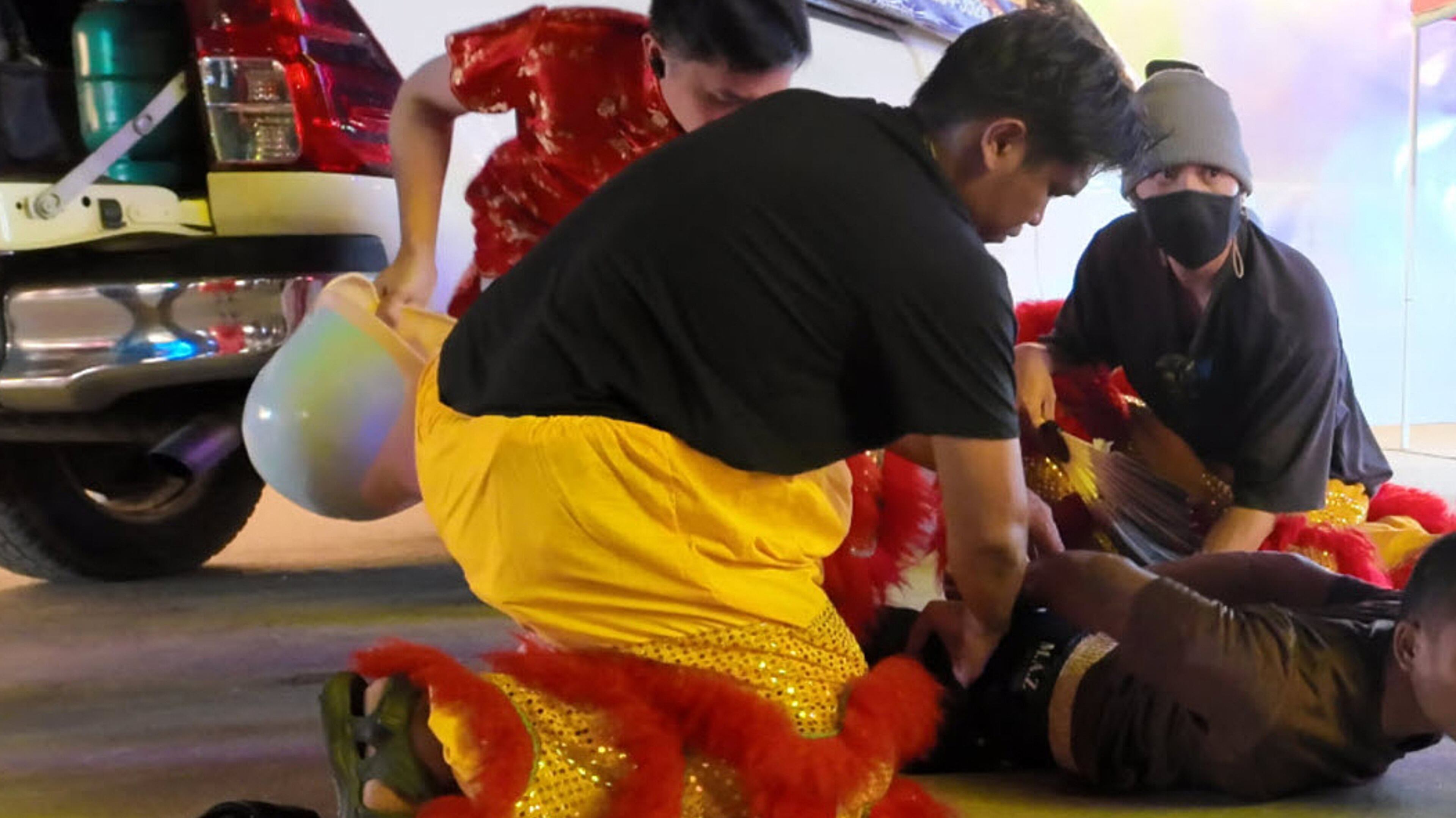 In this image released by Thailand’s Metropolitan Police Bureau, Thai police disguised as lion dance performers catch a burglary suspect at a temple fair in Nonthaburi province, Wednesday, Feb. 18, 2026. (The Metropolitan Police Bureau via AP)