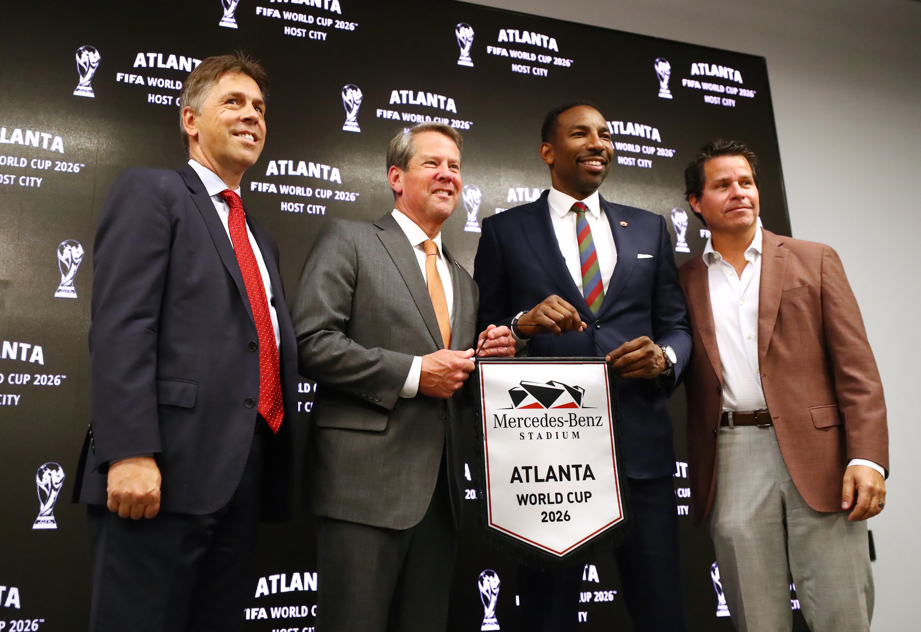 Dietmar Exler, Chief Operating Officer Mercedes-Benz Stadium (from left), Governor Brian Kemp, Mayor Andre Dickens, and Dan Corso, Atlanta Sports Council, take the stage during the Host City announcement press conference for the 2026 World Cup at Mercedes-Benz Stadium on Thursday, June 16, 2022, in Atlanta. Atlanta wants to get its short-term rental regulations in proper order ahead of this event and many others. “Curtis Compton / Curtis.Compton@ajc.com”