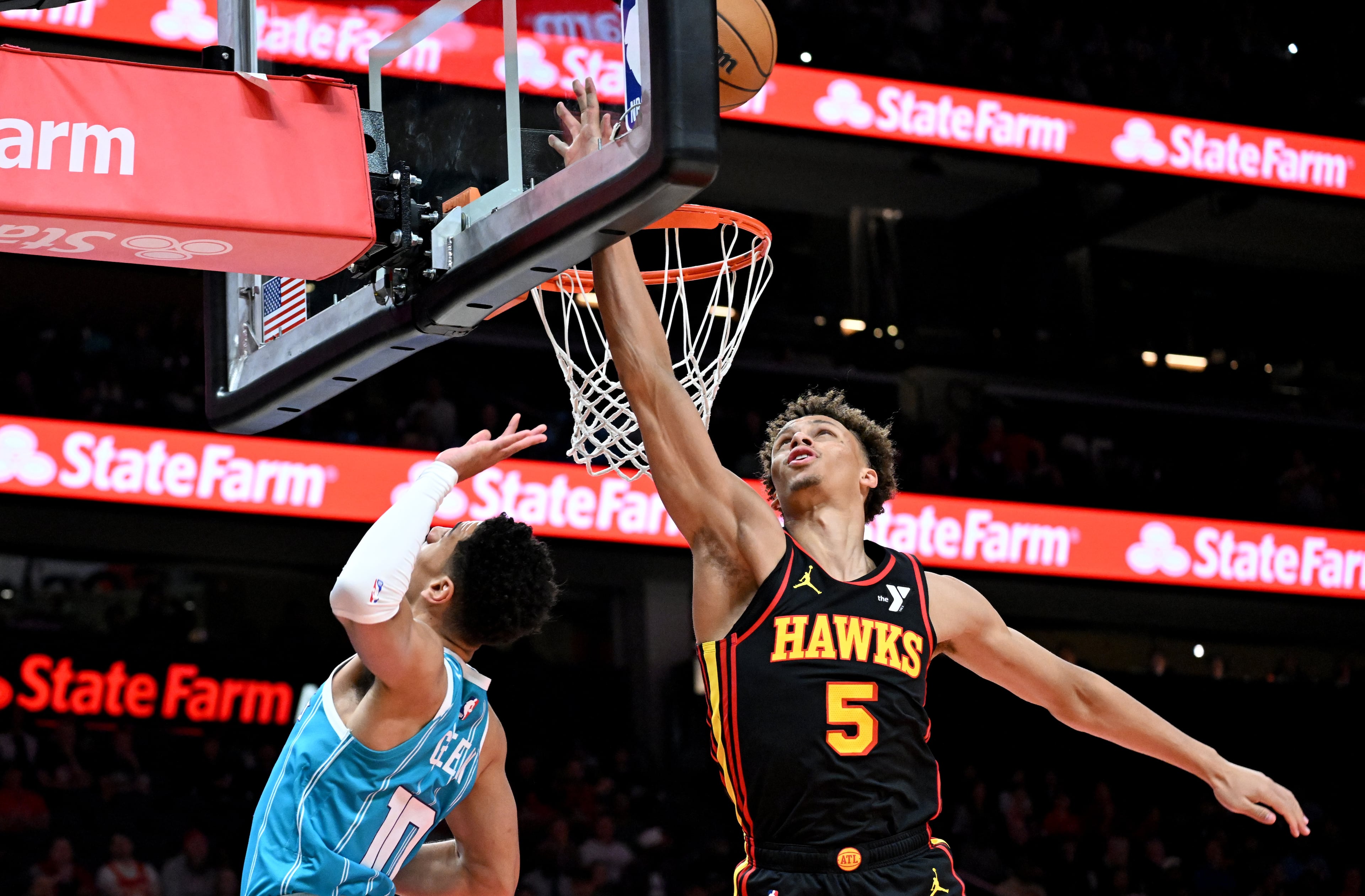 Atlanta Hawks guard Dyson Daniels (5) knocks the ball away from Charlotte Hornets guard Josh Green (10) during the first half in an NBA basketball game at State Farm Arena, Wednesday, March 12, 2025, in Atlanta. (Hyosub Shin / AJC)