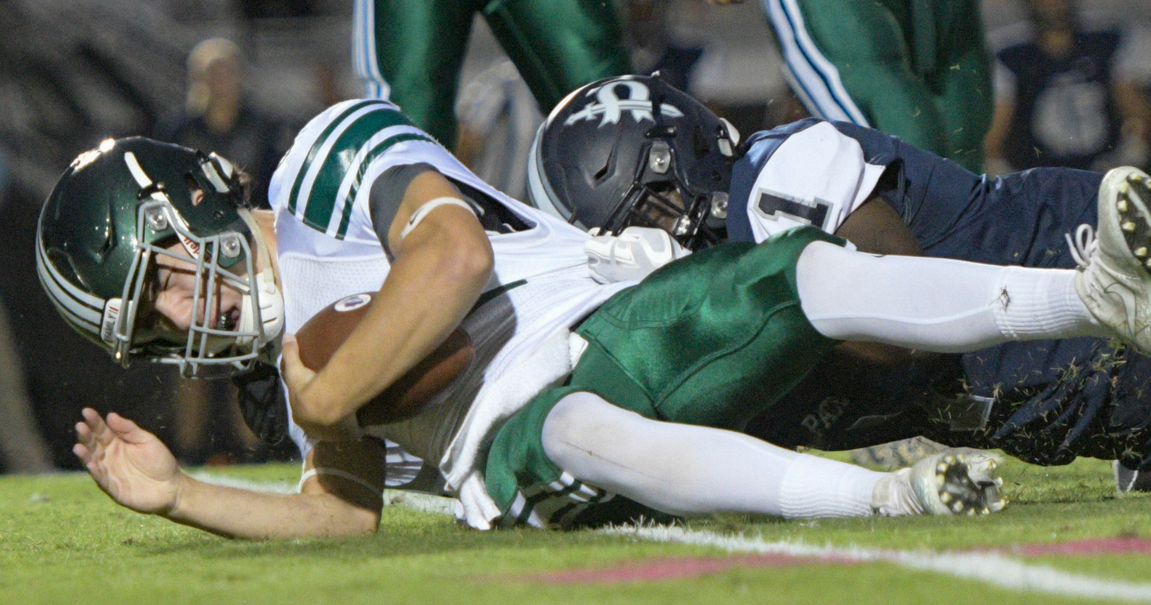 Westminster QB Chance Loeffler is brought down by Pace Academy DE Jaquari Wiggles during their high school football game Oct. 6, 2017, in Atlanta. (Special for the Atlanta Journal Constitution/John Amis)