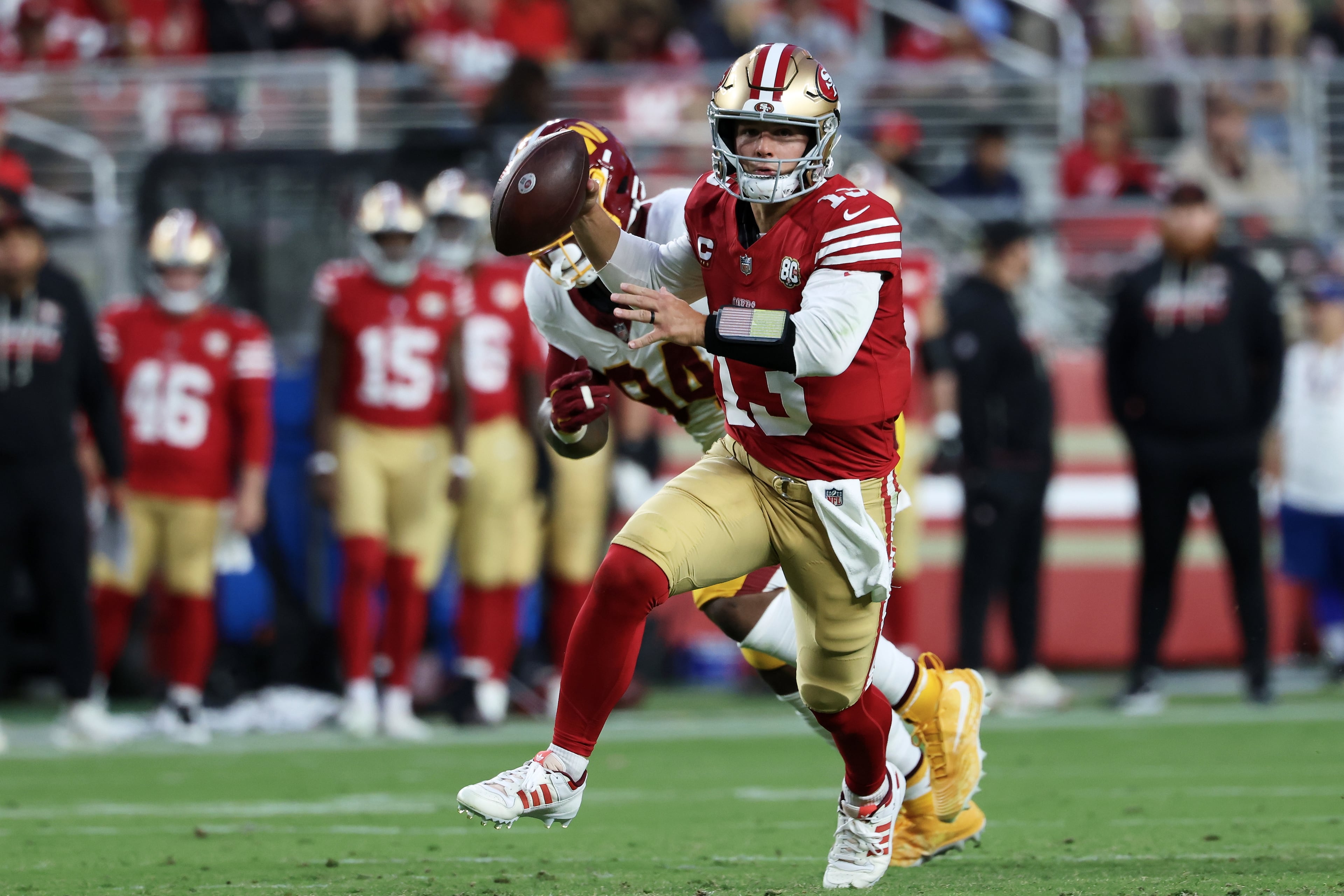 49ers quarterback Brock Purdy scrambles against the Commanders. (Jed Jacobsohn/AP)