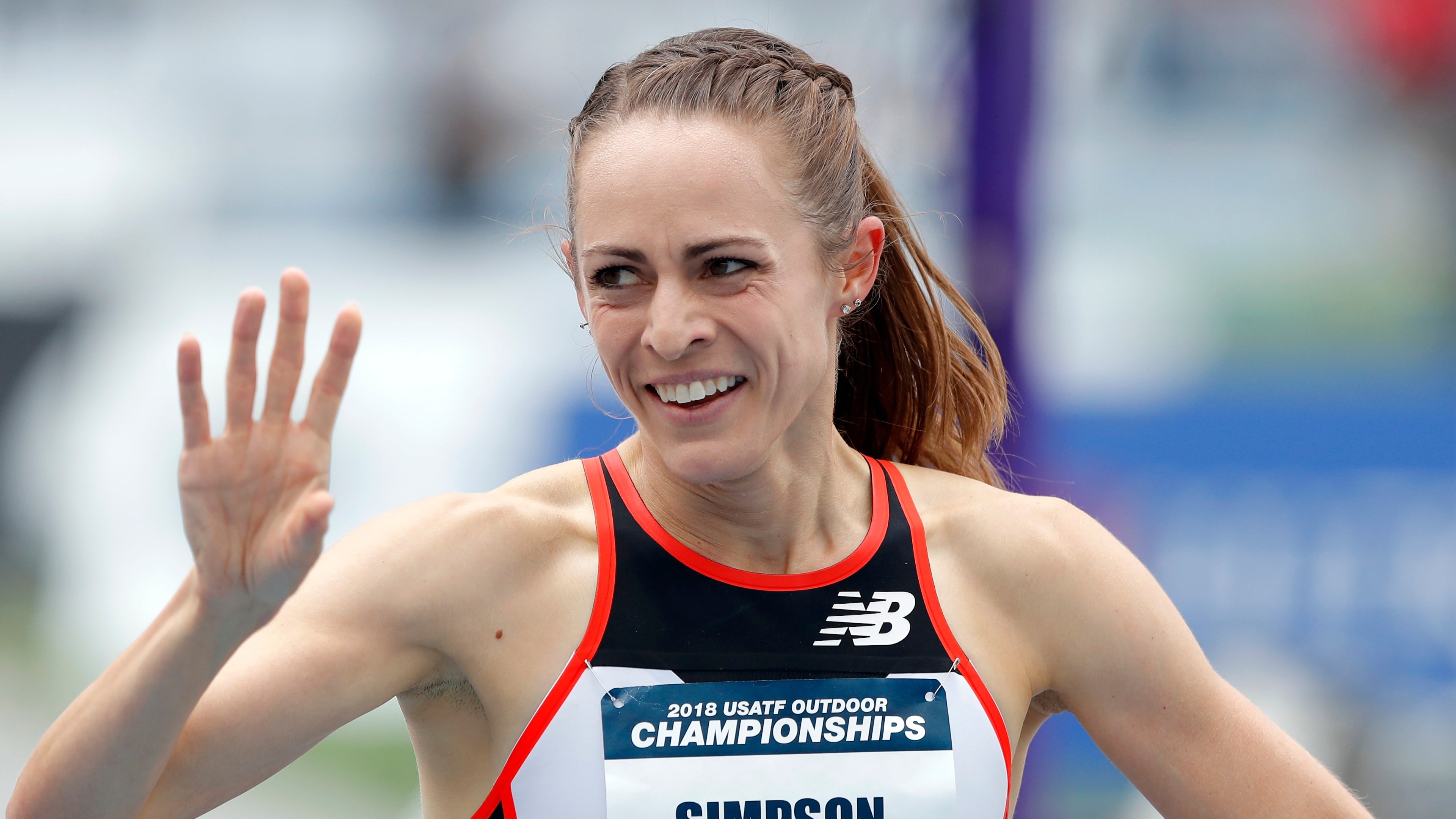 FILE - Jenny Simpson waves to a fan after winning her heat in the women's 1,500-meter run at the U.S. Championships athletics meet, Thursday, June 21, 2018, in Des Moines, Iowa. (AP Photo/Charlie Neibergall, File)