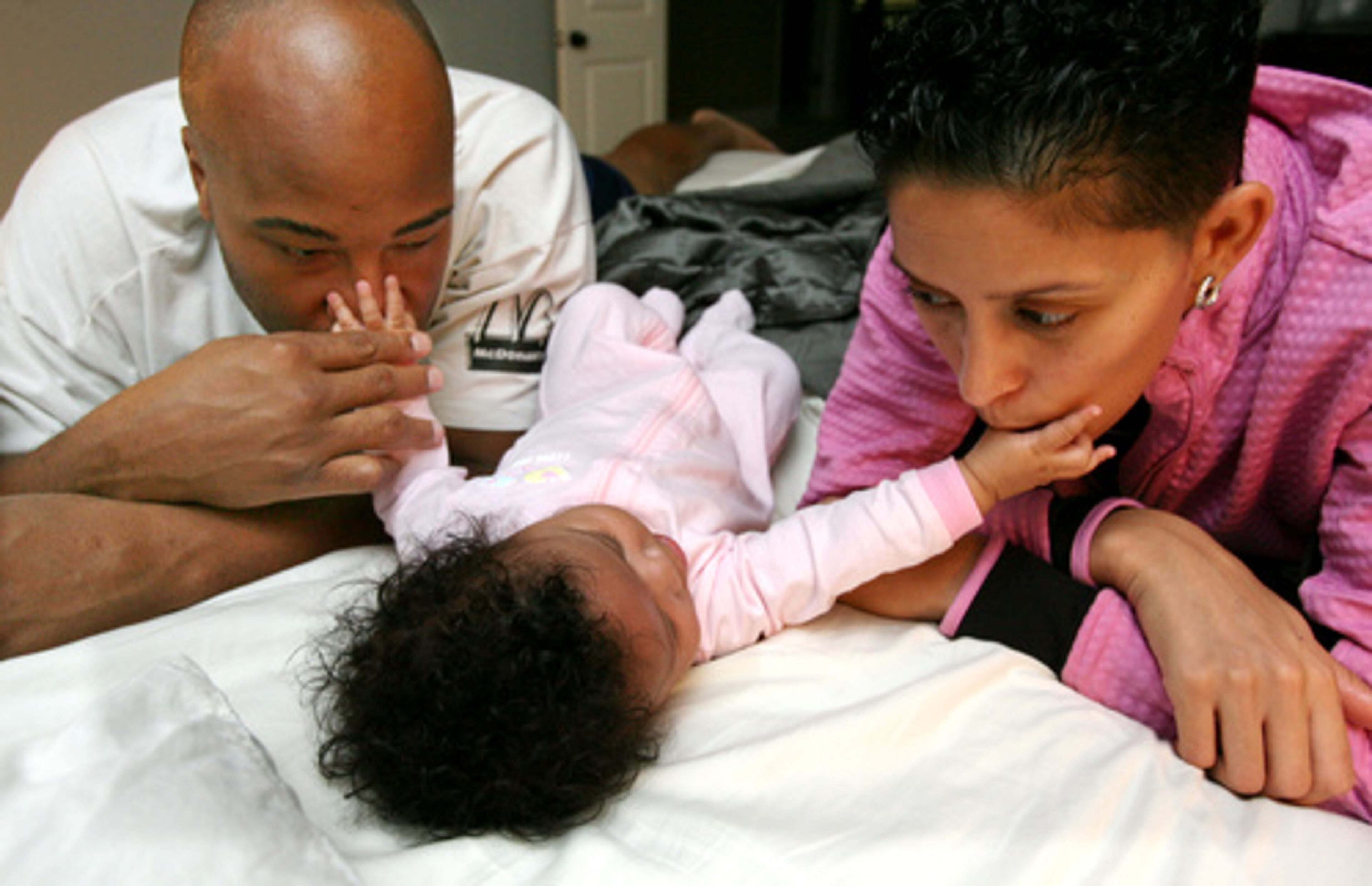 Danielle Beverly returns home from radiation treatment in time to share a tender moment with her husband, Eric, and their daughter, Lia.