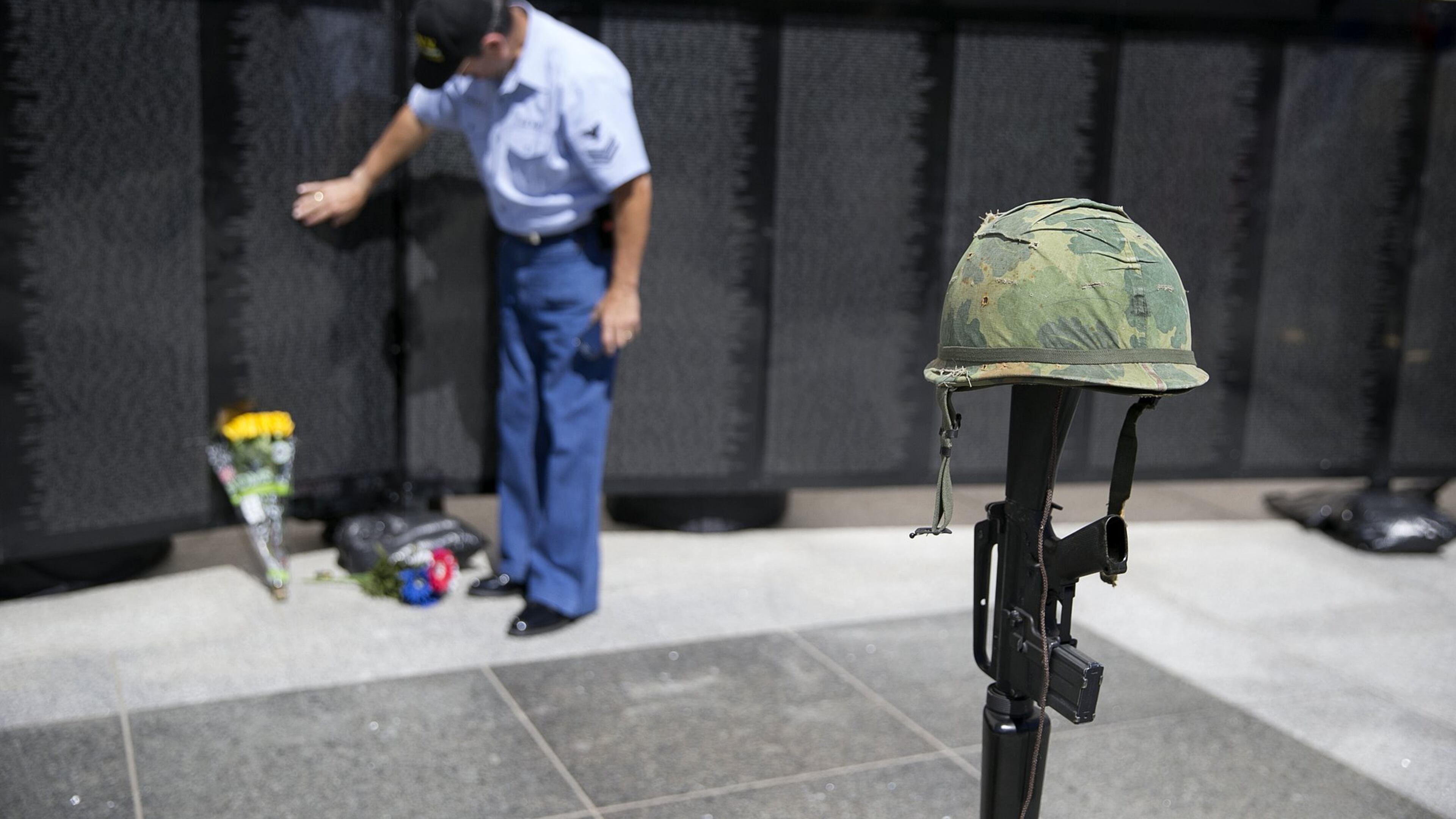 Luis L. Gonzalez, a Navy veteran, places his fingers on a name on “The Wall That Heals,” a half-scale replica of the Vietnam Veterans Memorial in Washington, D.C. The Wall comes to Johns Creek March 30.