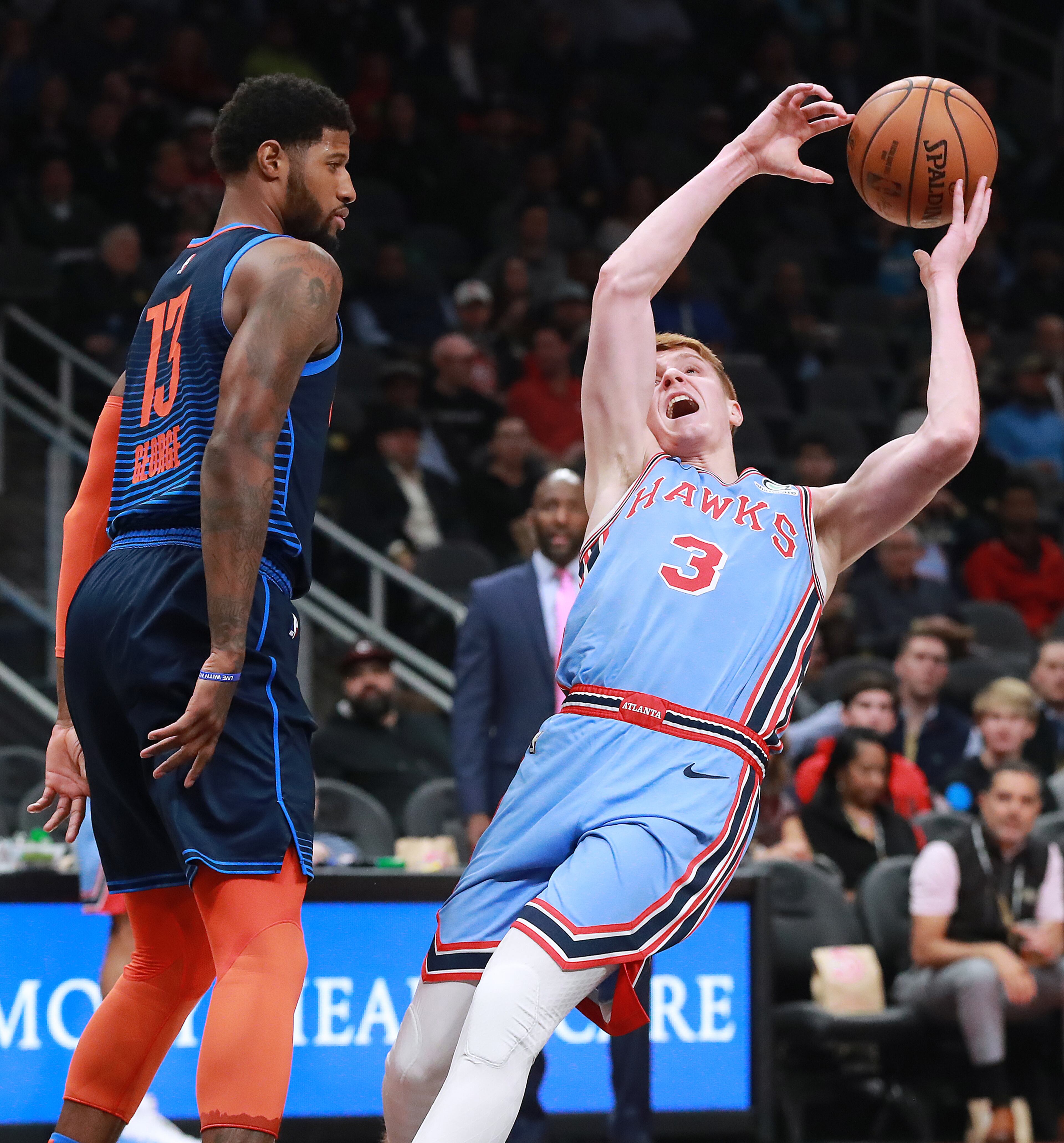 Jan. 15, 2019 Atlanta: Atlanta Hawks guard Kevin Huerter draws a foul from Oklahoma City Thunder forward Paul George during the first half in a NBA basketball game on Tuesday, Jan. 15, 2019, at State Farm Arena in Atlanta. Curtis Compton/ccompton@ajc.com