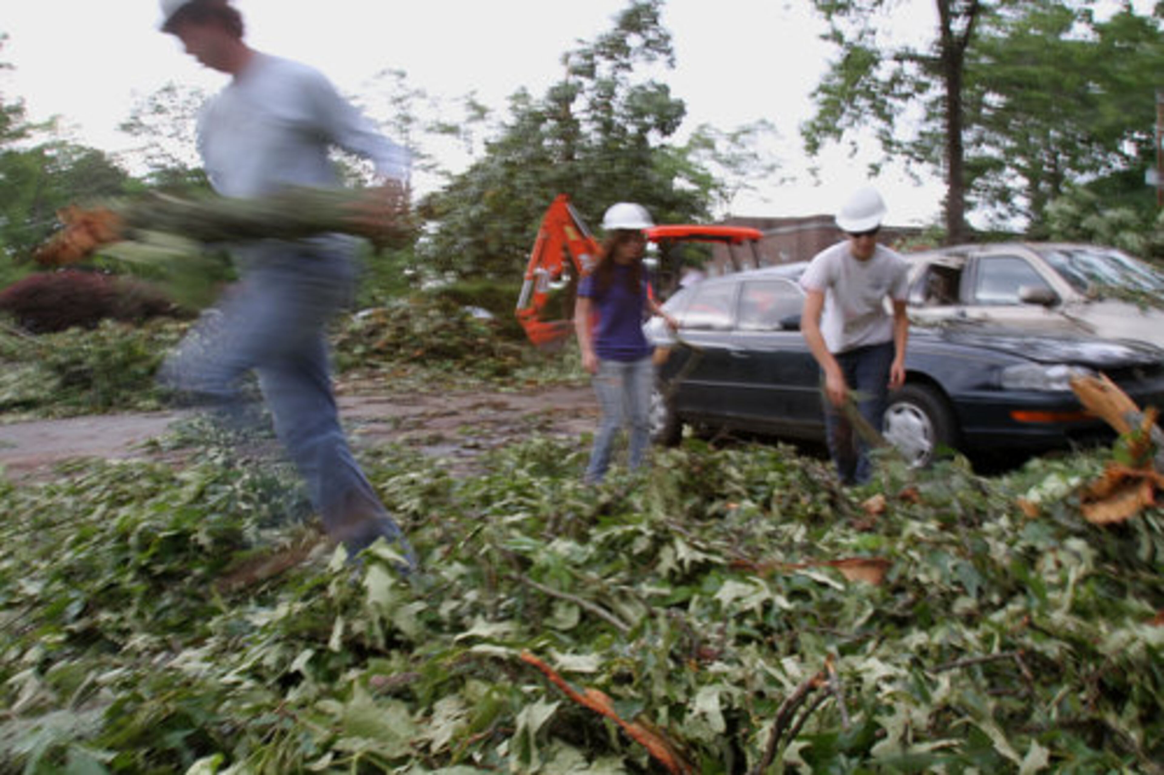 Students at Berry College help clean up after trees were uprooted at the school in Rome.