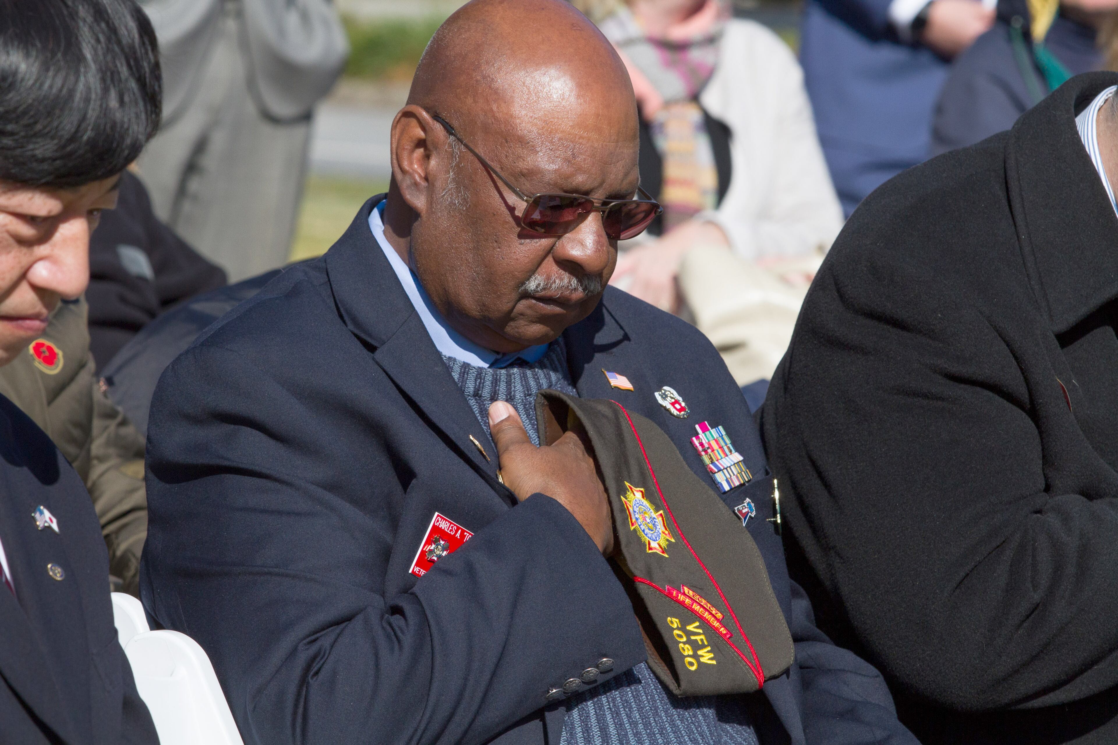 Charles A. Dobbins lowers his head throughout the invocation during the 2018 Veterans Day Commemoration at the Atlanta History Center on Sunday, November 11, 2018. (Photo; STEVE SCHAEFER / SPECIAL TO THE AJC)