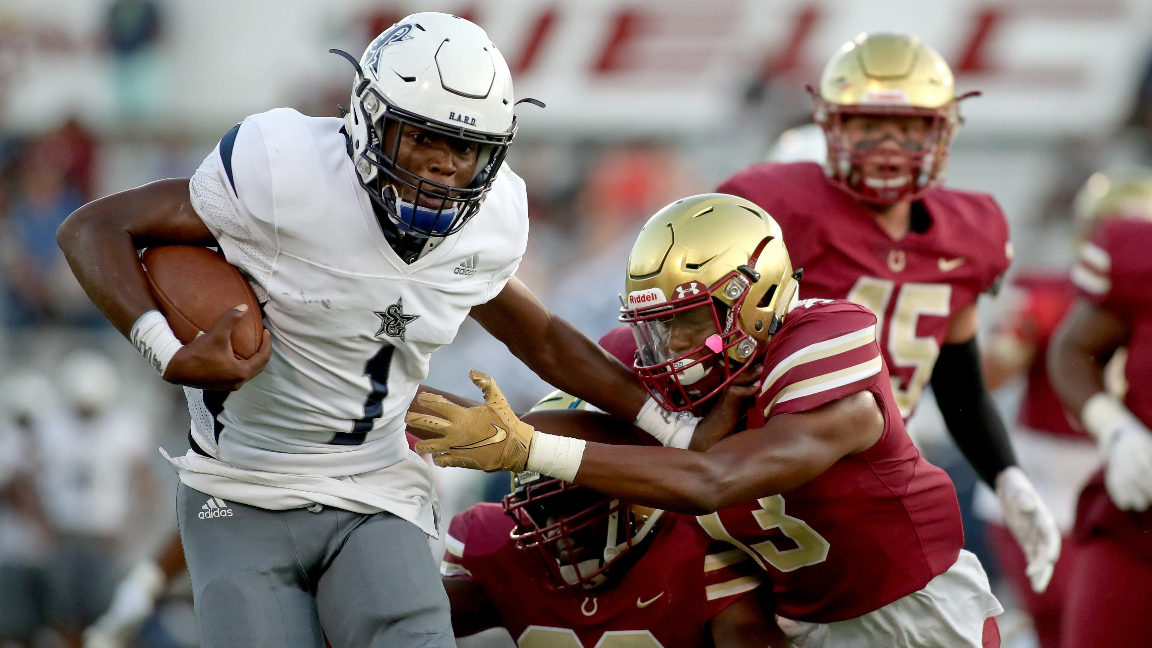 South Gwinnett quarterback Tre Truitt (1) runs against Brookwood linebacker Jacob Brown (33) and Jacob Burrell (13) in the first half of Friday's game. (Daniel Varnado/Special)